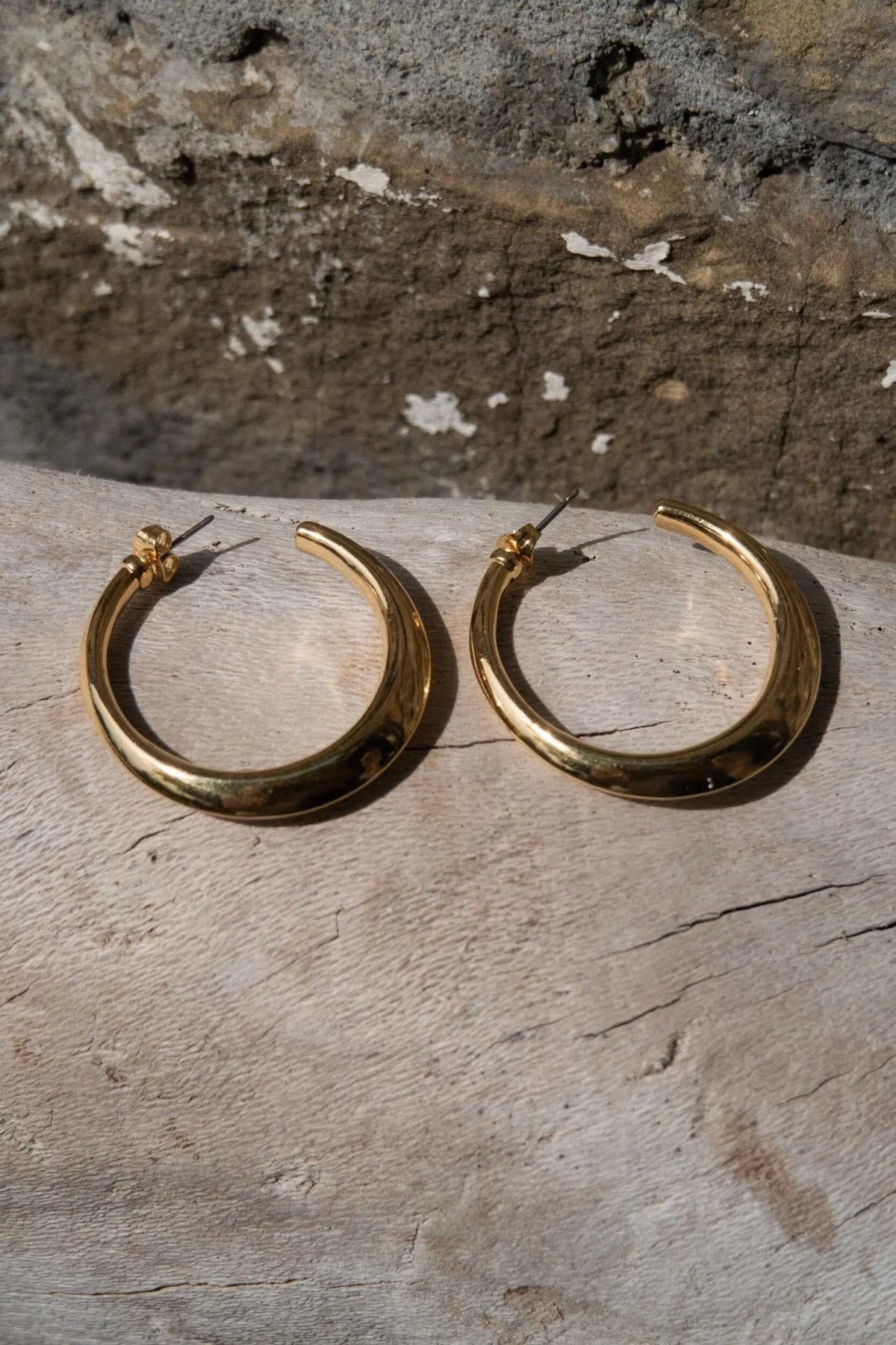 Minimalist 24k gold plated hoop earrings in polished gold-tone metal with smooth open circular hoops
