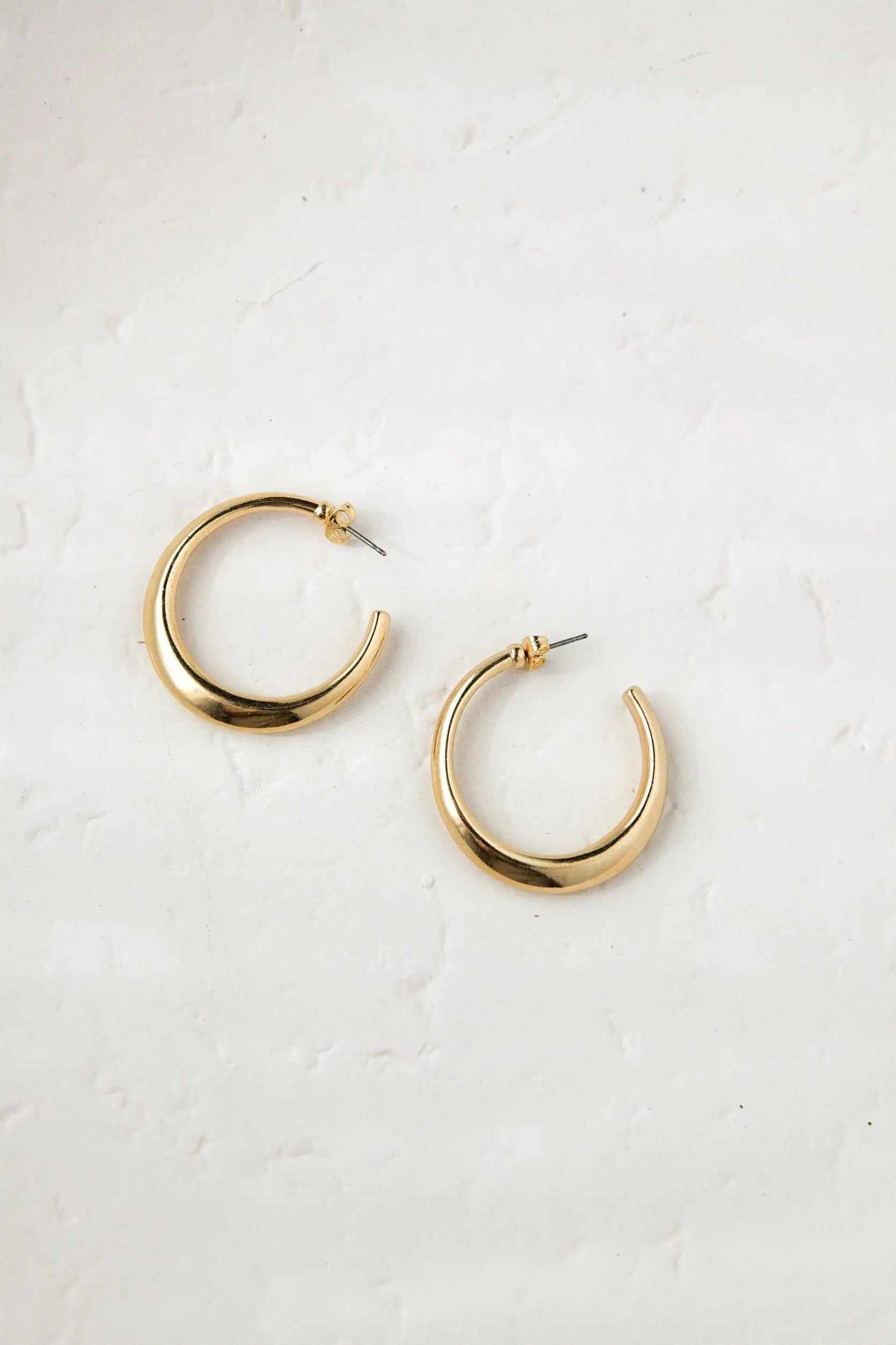 Minimalist 24k gold plated hoop earrings in polished gold-tone metal with open circular hoops and titanium pins