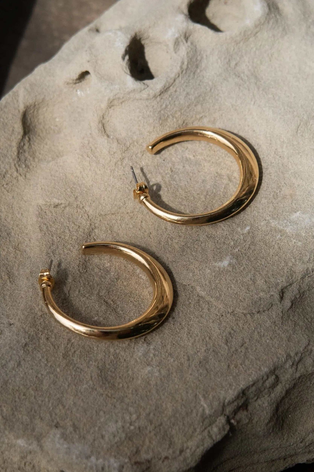 Minimalist 24k gold plated hoop earrings, polished gold-tone brass with open curved hoops and titanium pins