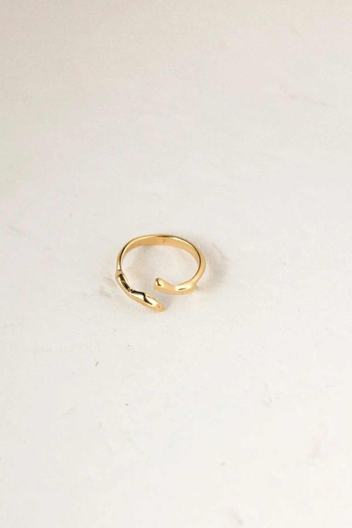Minimalist gold filled ring in a polished gold-tone finish, with a delicate open, gently curved geometric band
