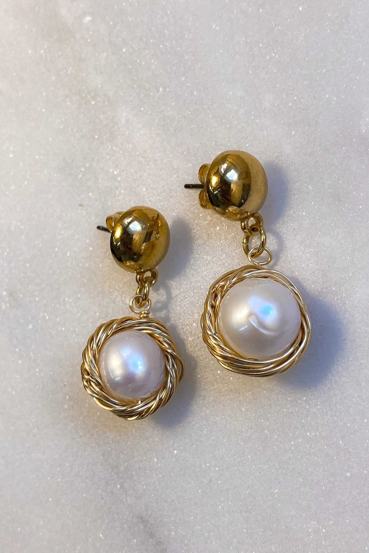 Mother of pearl Earrings with round iridescent white pearls encircled by twisted gold-tone wire and gold ball studs