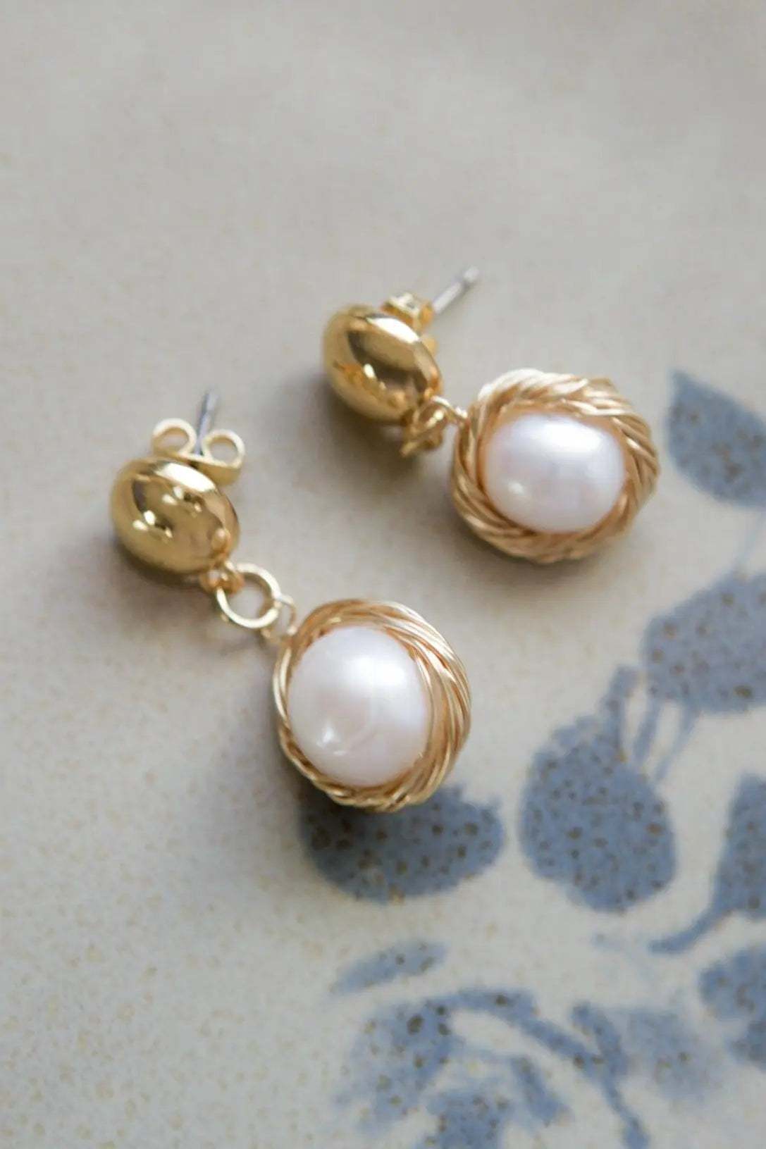 Mother of pearl Earrings with white freshwater pearls in textured gold-tone metal settings and stud backs