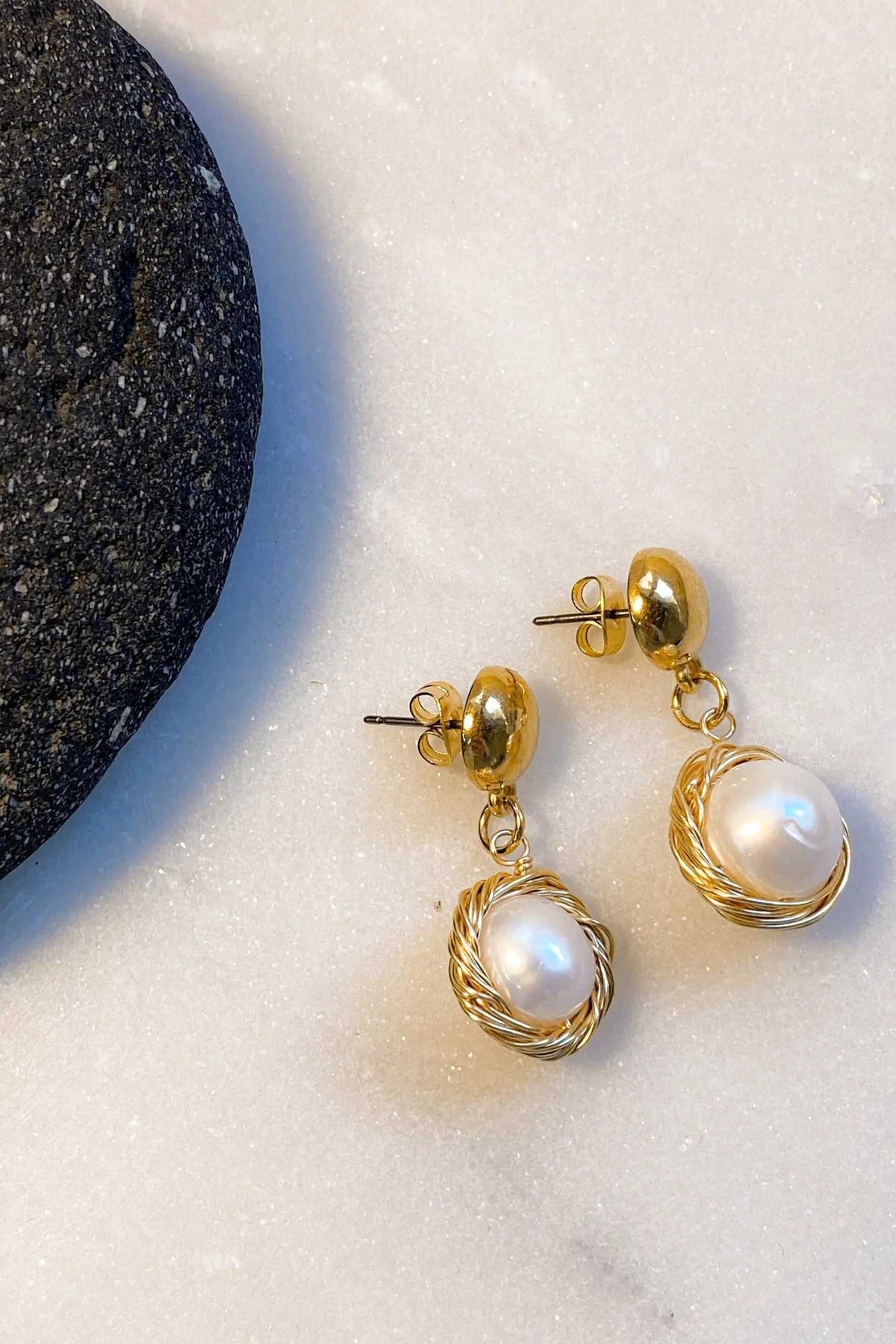 Mother of pearl Earrings with luminous white pearl drops, gold-toned metal frames, and twisted wire detailing