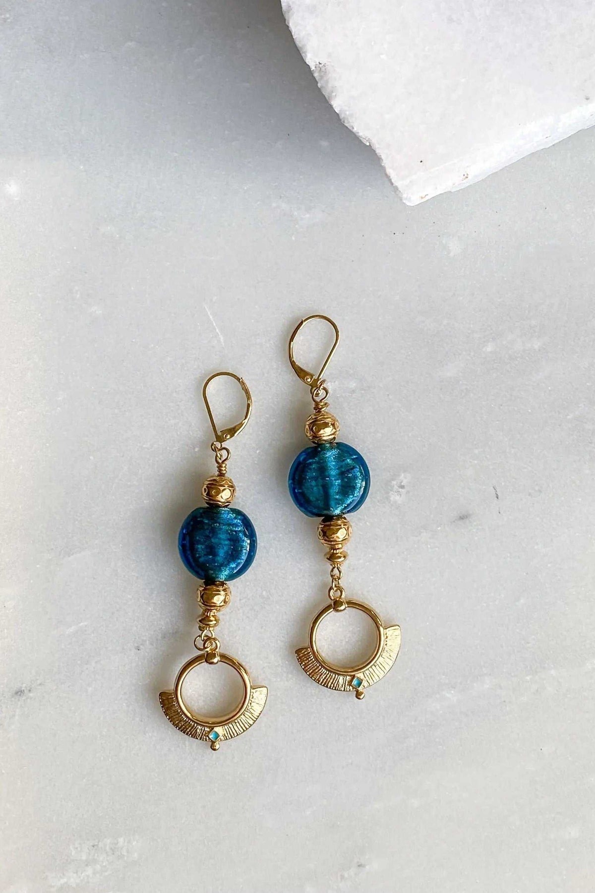 ODYSSOS EARRINGS, long gold-tone earrings with blue glass beads and ornate circular drop charms