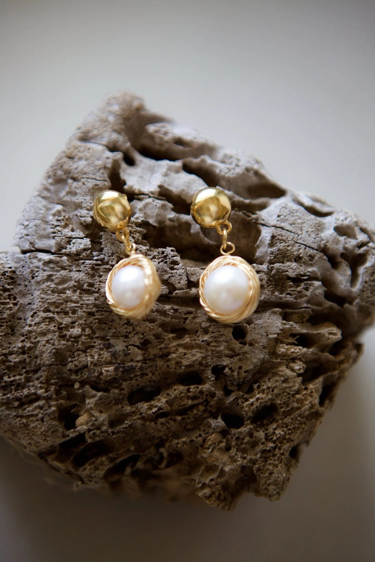 Pearl wreath Earrings in gold-tone metal with luminous white pearls, featuring rounded pearl drops suspended from textured bead studs.