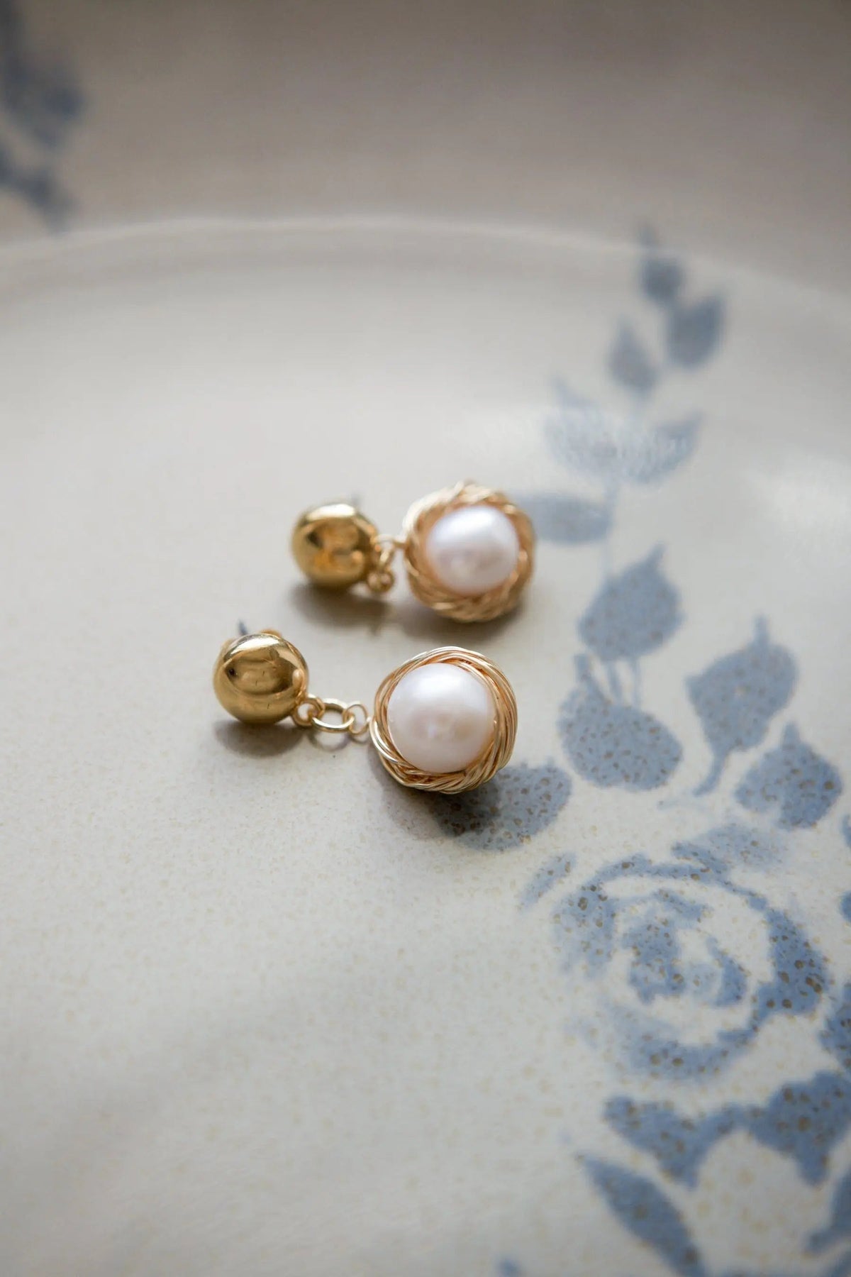 Pearl wreath Earrings with round white pearls wrapped in delicate gold wire and polished gold-tone stud backs.