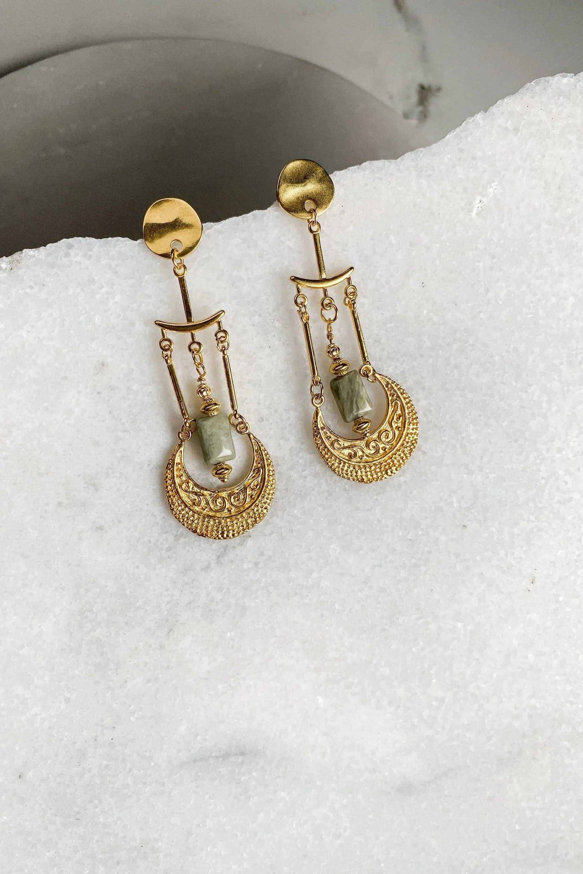 PITHÓ EARRINGS are gold-tone brass dangle earrings with ornate filigree drops and dangling pale green stones