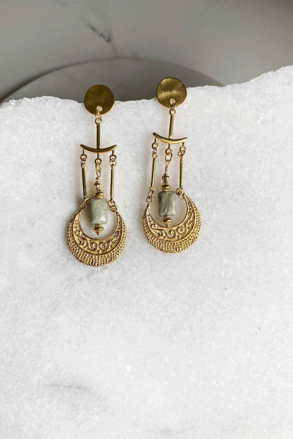 PITHÓ EARRINGS in gold-tone brass feature ornate dangling discs with pale green stones and chain details