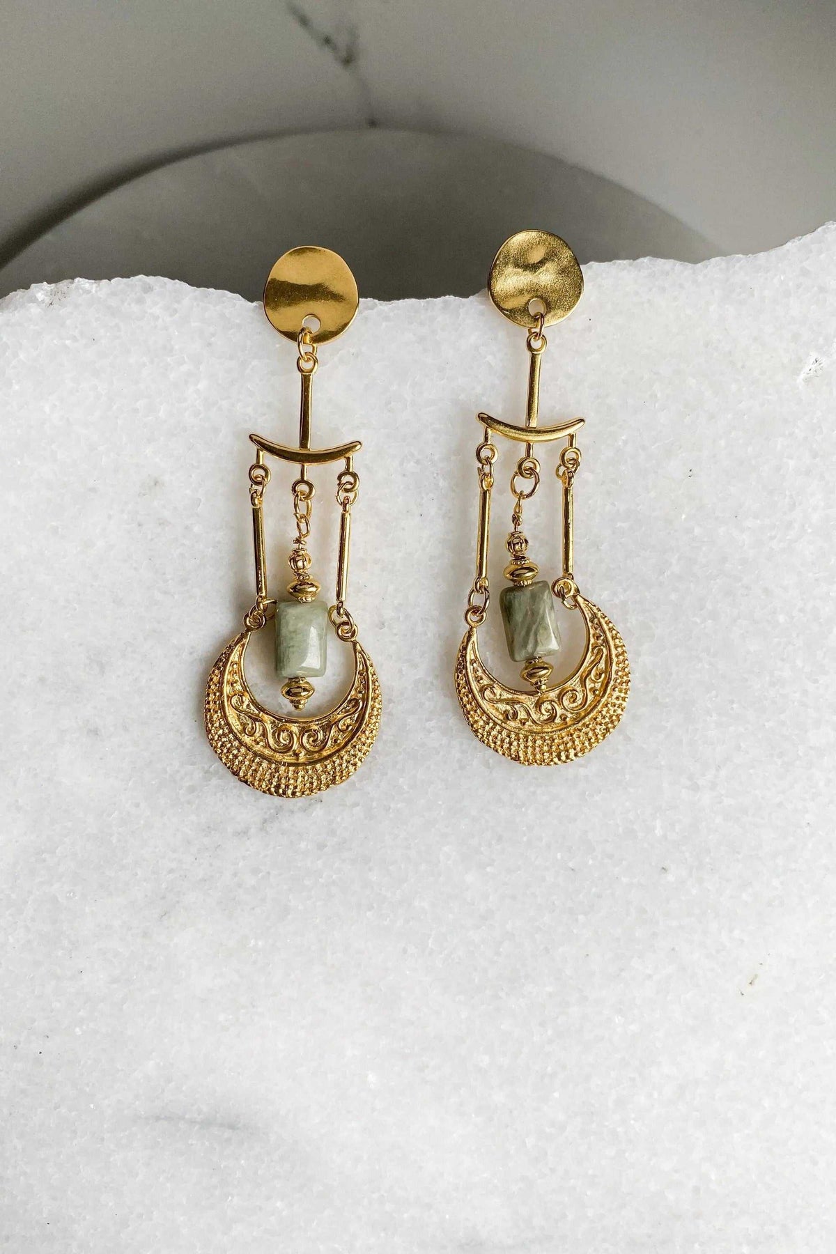 PITHÓ EARRINGS, gold-toned statement earrings with ornate circular filigree and pale green stone drops