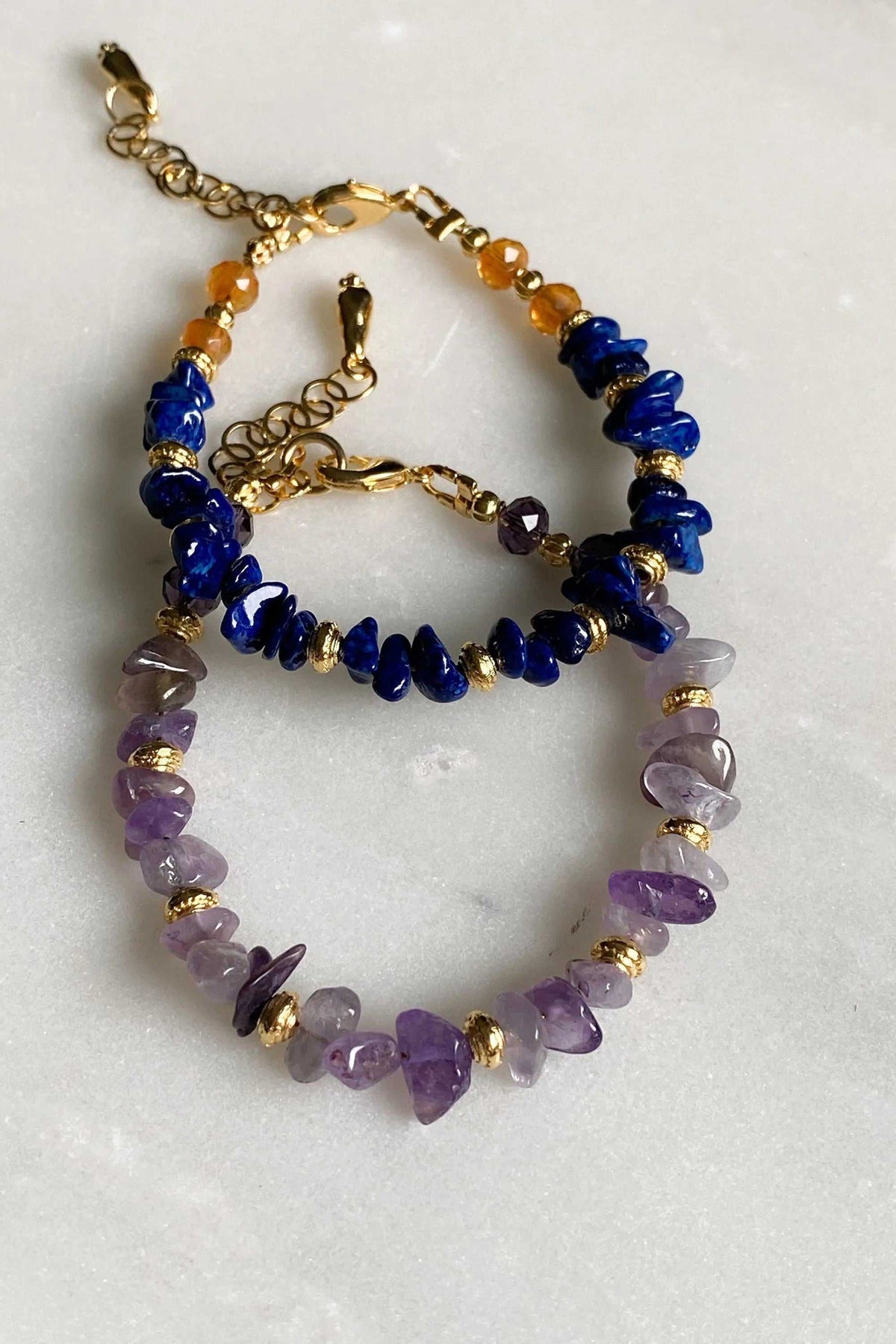 POLYMNIA BRACELET with purple and deep blue natural stone chips, gold-tone accents, and an adjustable chain clasp