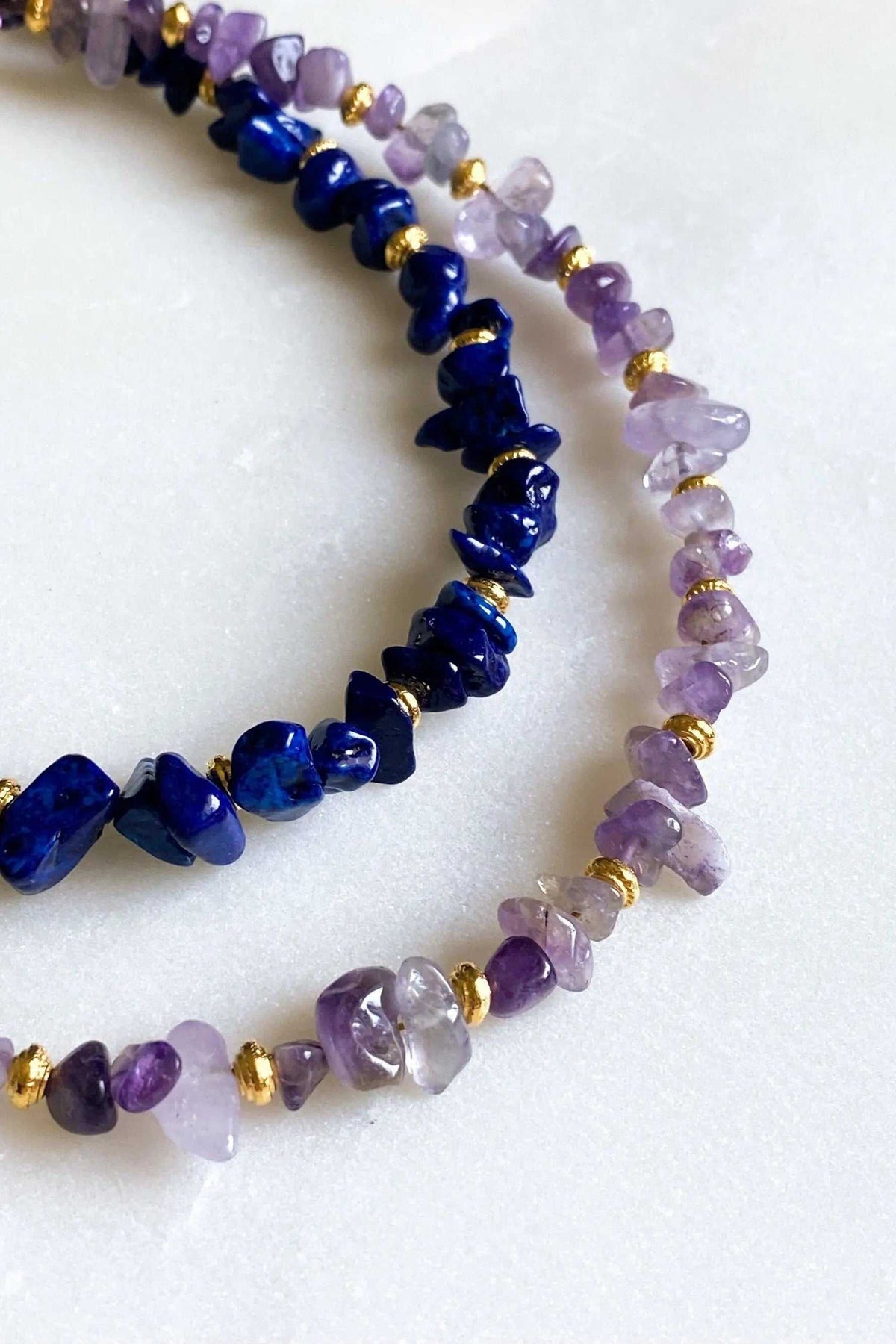 POLYMNIA NECKLACE with irregular lavender and deep blue stone chips separated by small gold-tone beads