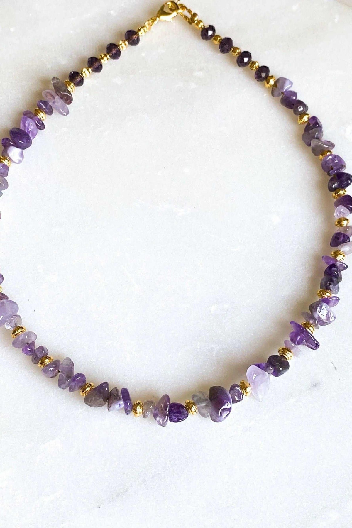 POLYMNIA NECKLACE featuring a purple amethyst chip strand with small gold-plated spacer details and clasp