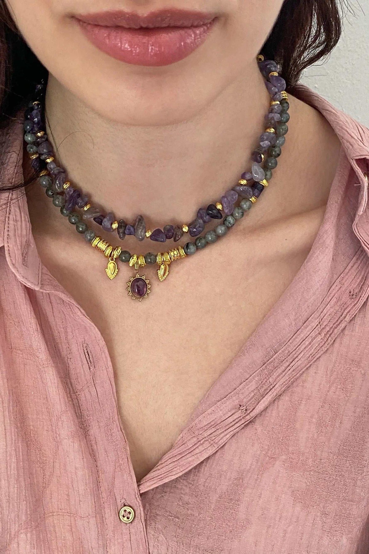 POLYMNIA NECKLACE with purple and gray faceted stones, gold-plated accents, and a dangling oval purple pendant