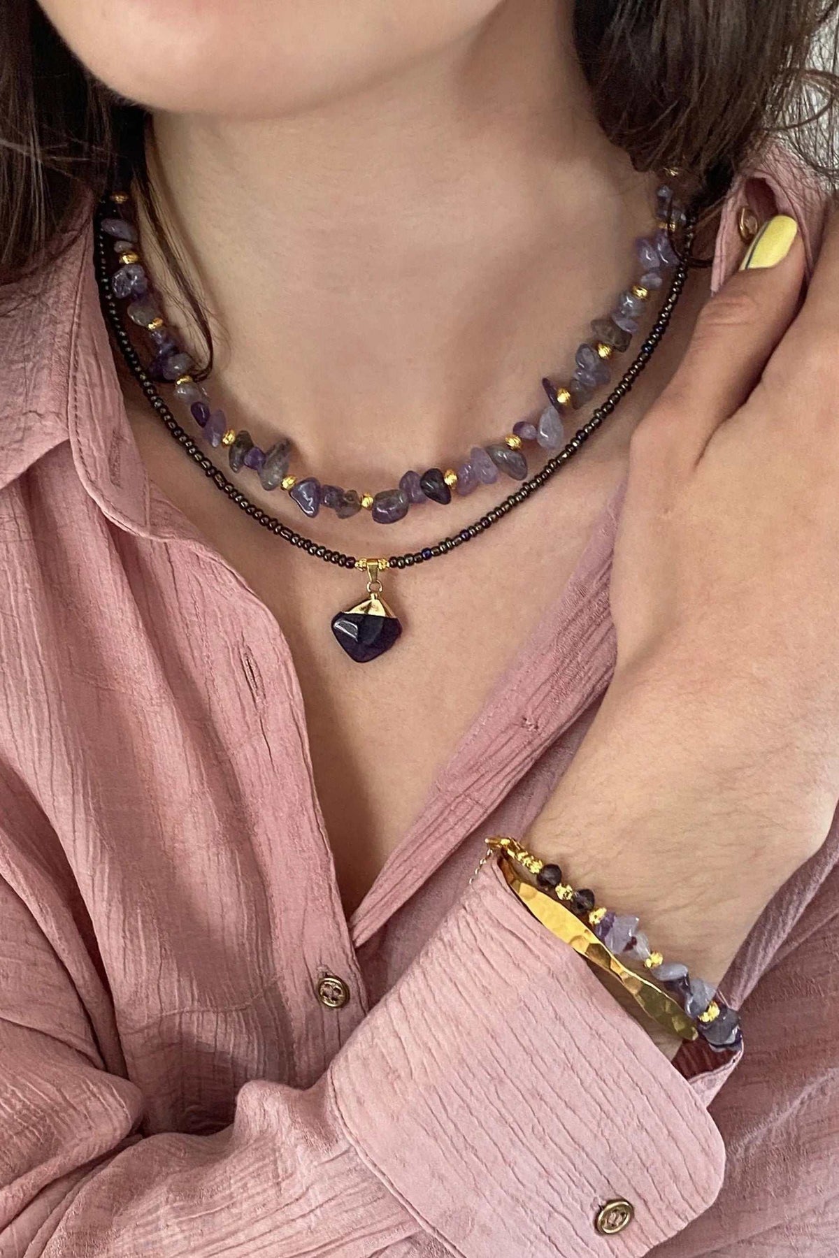 POLYMNIA NECKLACE with purple and gold-toned stone beads, a black faceted pendant, and delicate gold-plated details