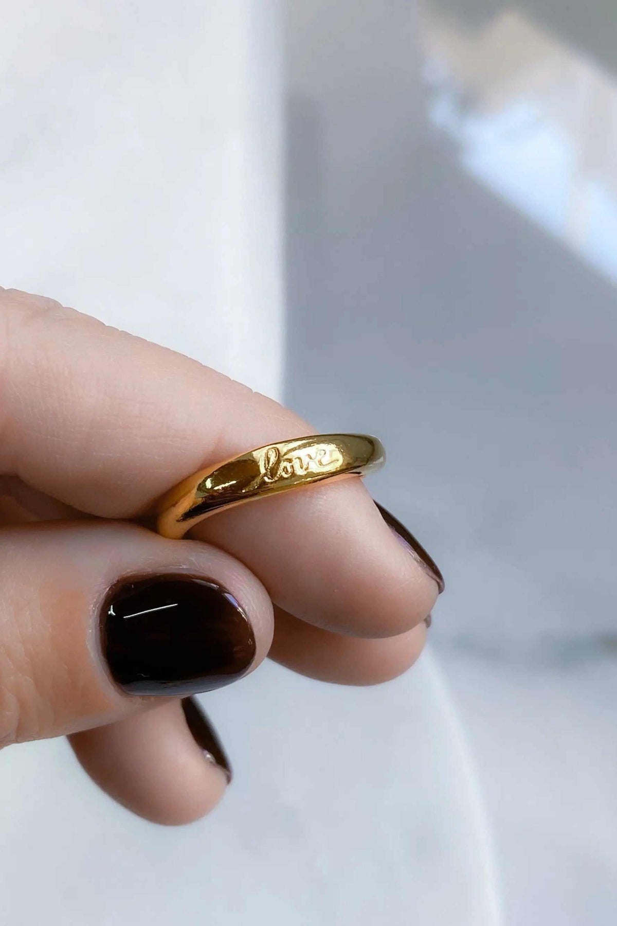 Promise LOVE ring, slim polished gold band with a raised half-round shape and engraved script lettering