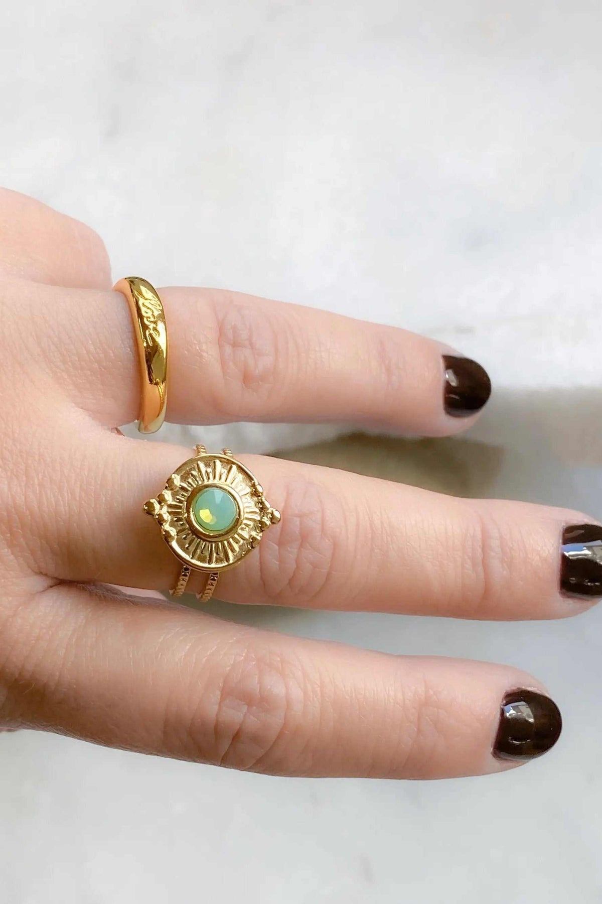 Promise LOVE ring pair with slim polished gold bands, including an engraved band and a sunburst ring with a turquoise center
