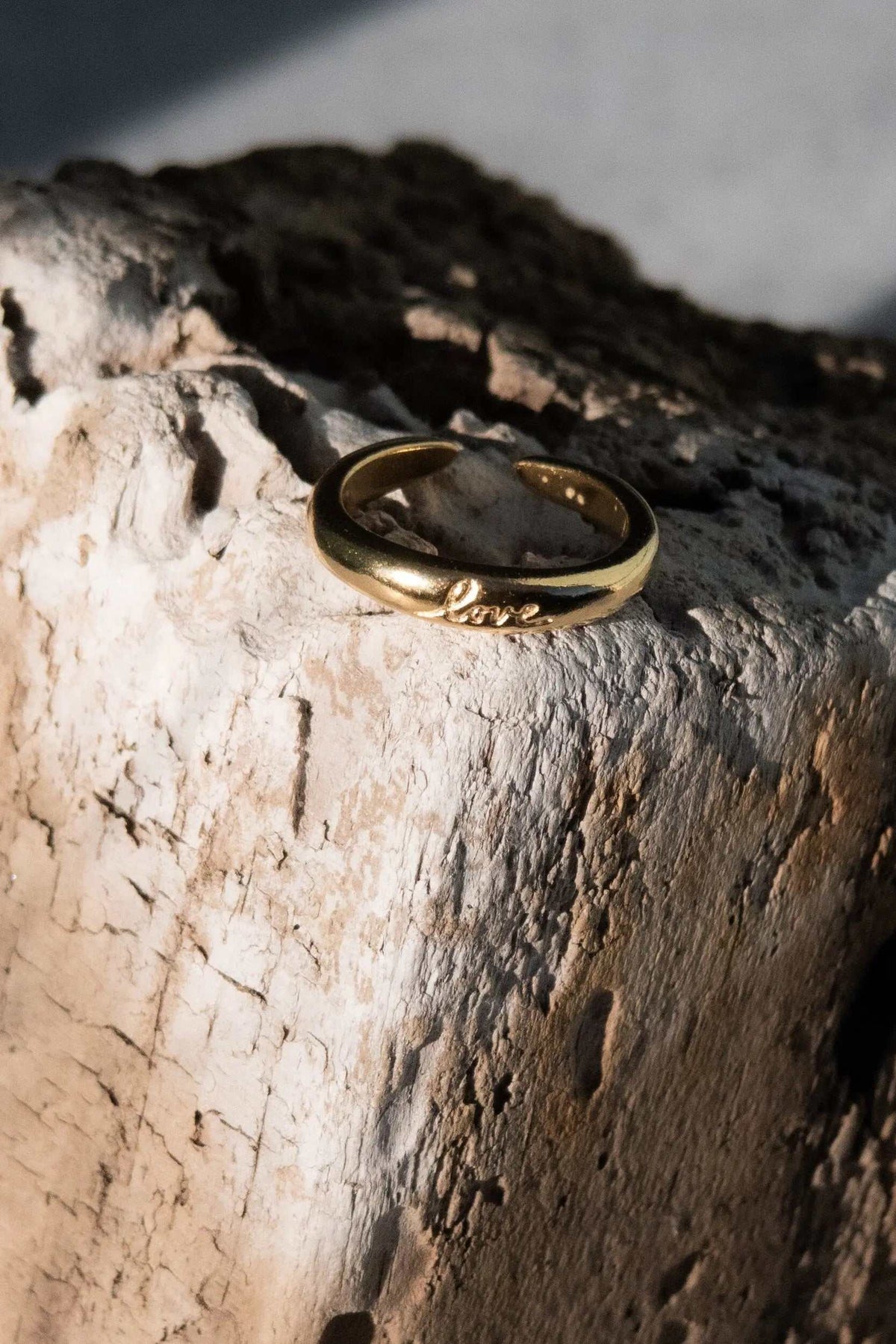 Promise LOVE ring, gold-tone smooth domed band with an open adjustable back and raised LOVE lettering