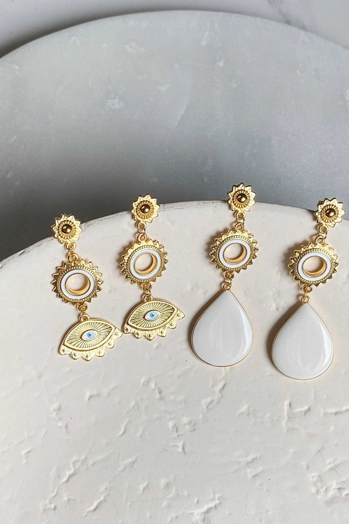 PYTHIA Statement Evil eye earrings in gold-tone metal feature blue and white enamel eye motifs and teardrop pendants.