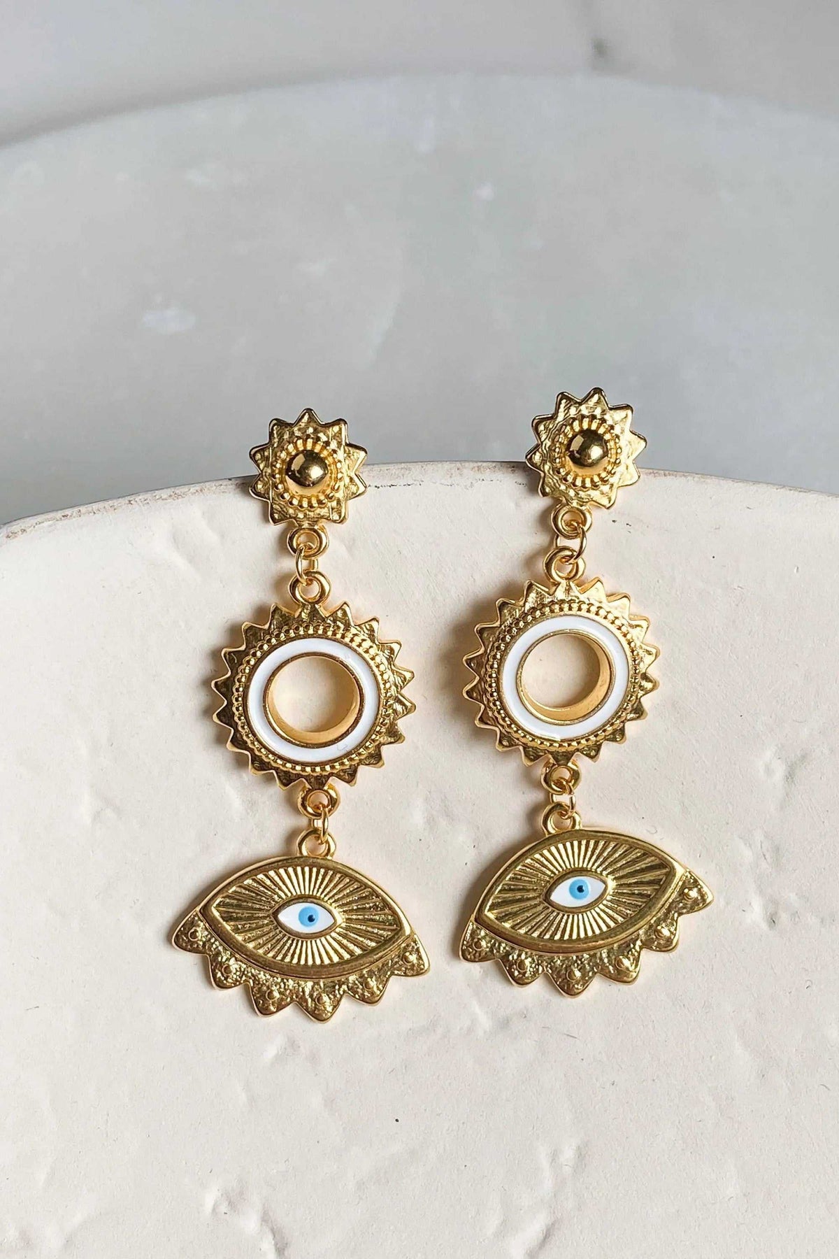 PYTHIA Statement Evil eye earrings in ornate gold-tone metal with sunburst circles, cream enamel and blue-eyed motifs