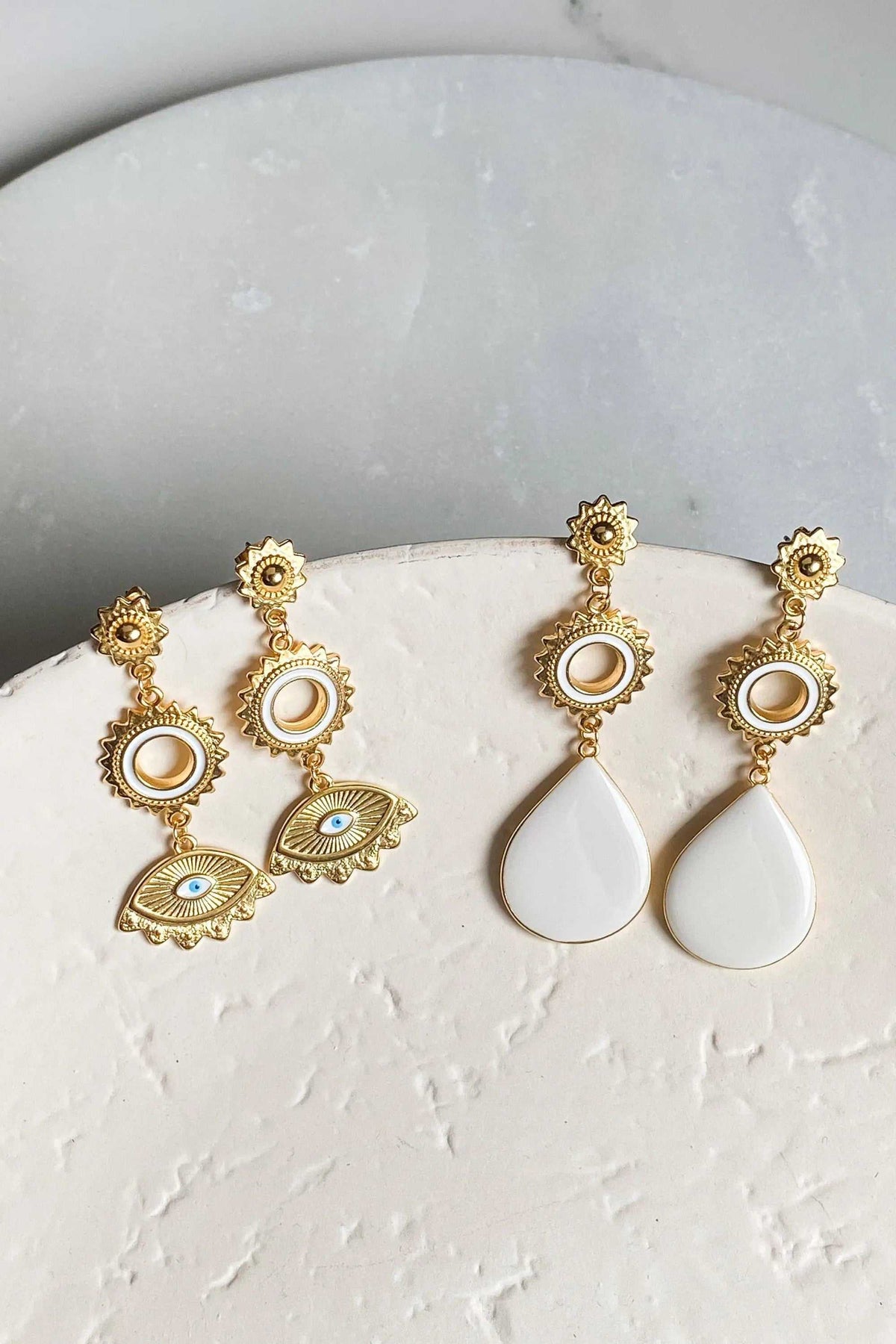 PYTHIA Statement Evil eye earrings in gold-tone metal with white enamel eyes and dangling teardrop charms