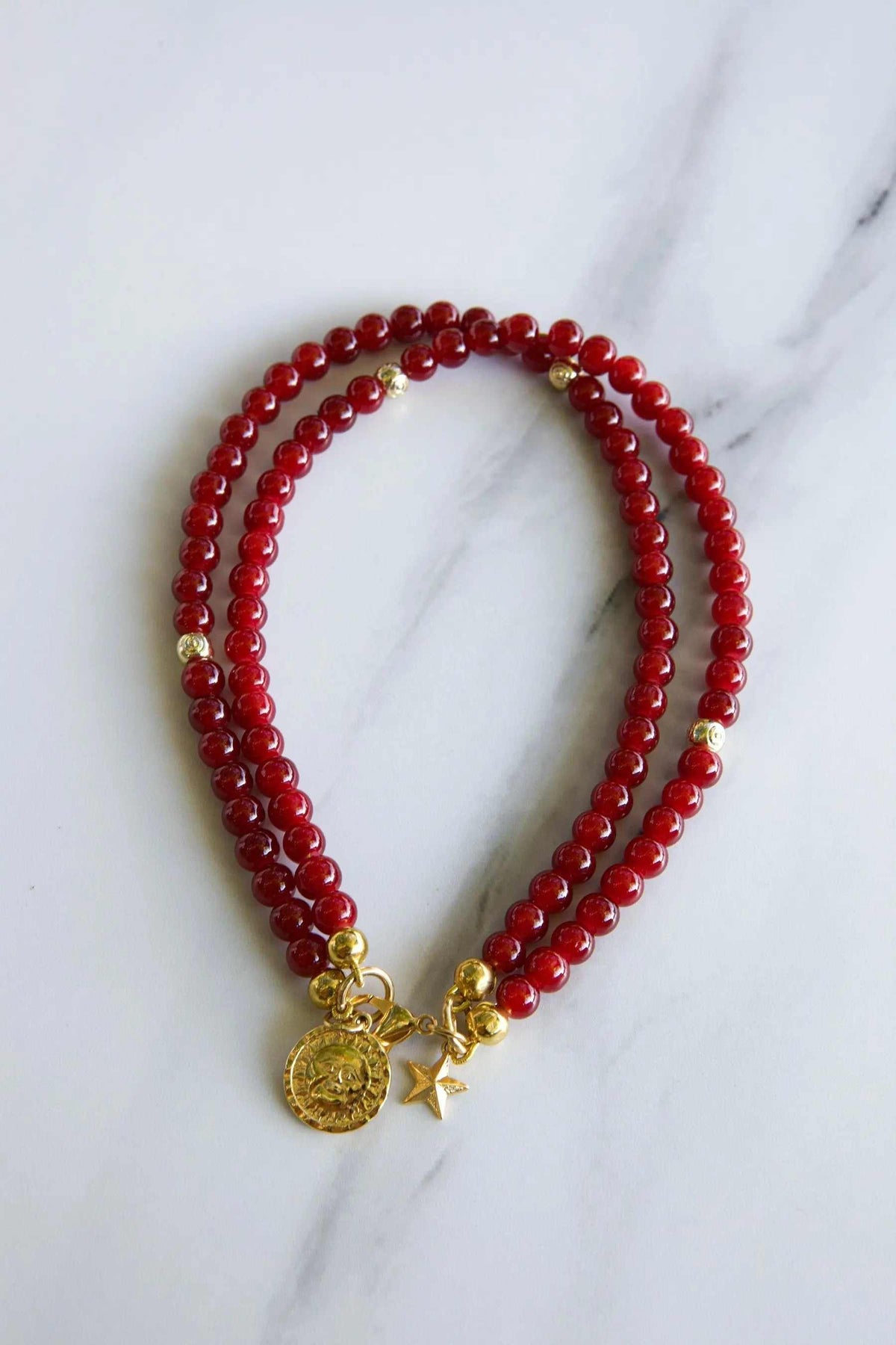 Red crystal beaded Bracelet with glossy deep red round beads, gold-tone spacers and dangling coin and star charms