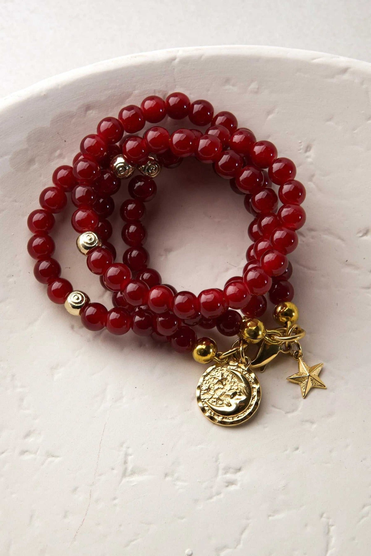 Red crystal beaded Bracelet with glossy deep red round beads, gold-tone spacers and dangling coin and star charms