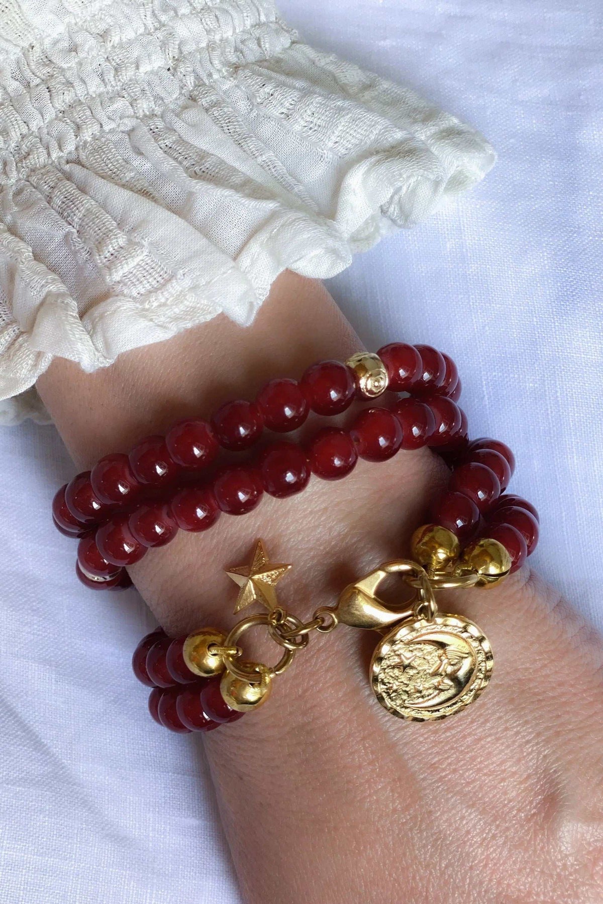 Red crystal beaded Bracelet with glossy deep red round beads, wrapped in multiple strands and finished with gold-tone charms