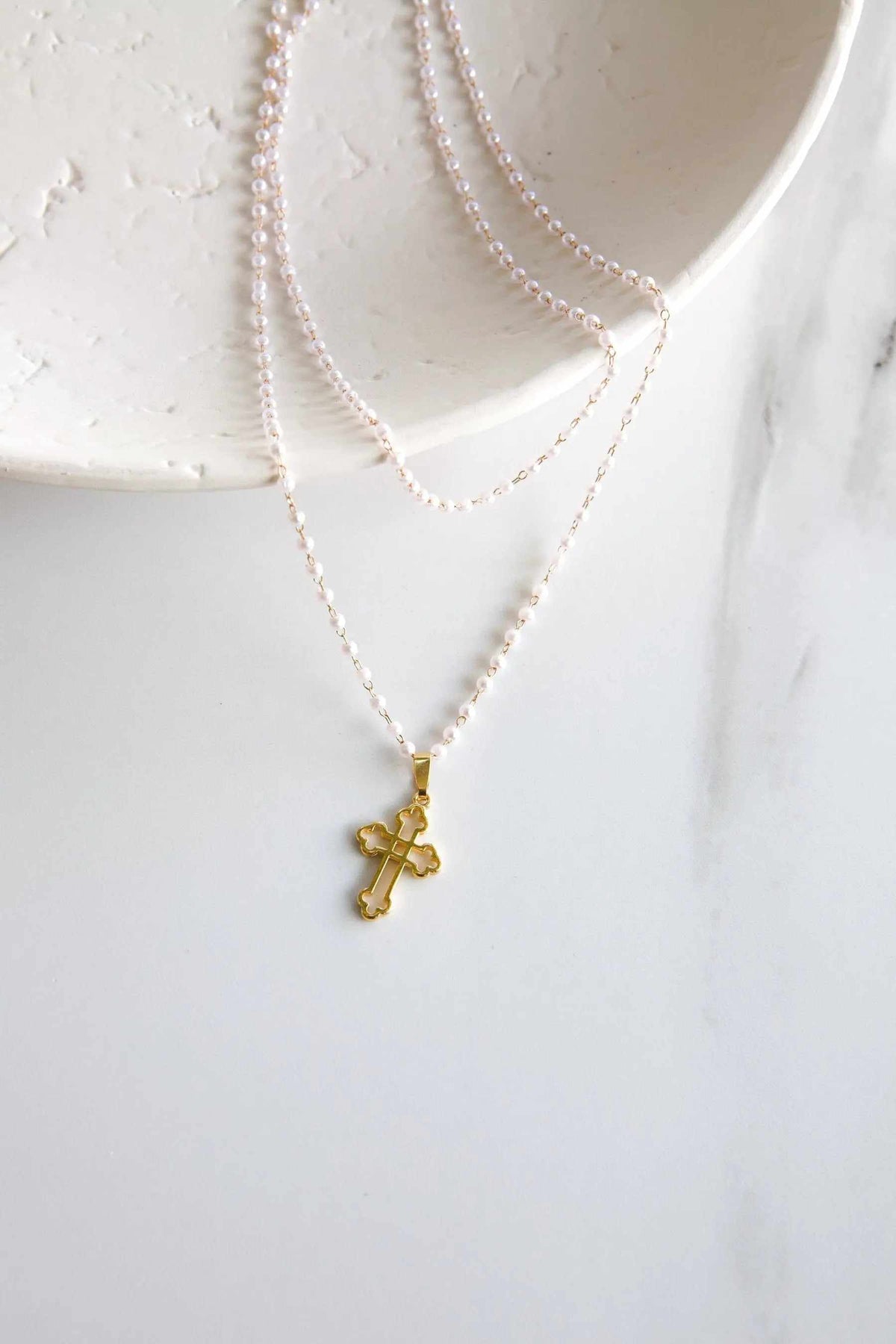 Rosario Pearls Bracelet with delicate pale pink beads and a gold-tone Byzantine cross pendant