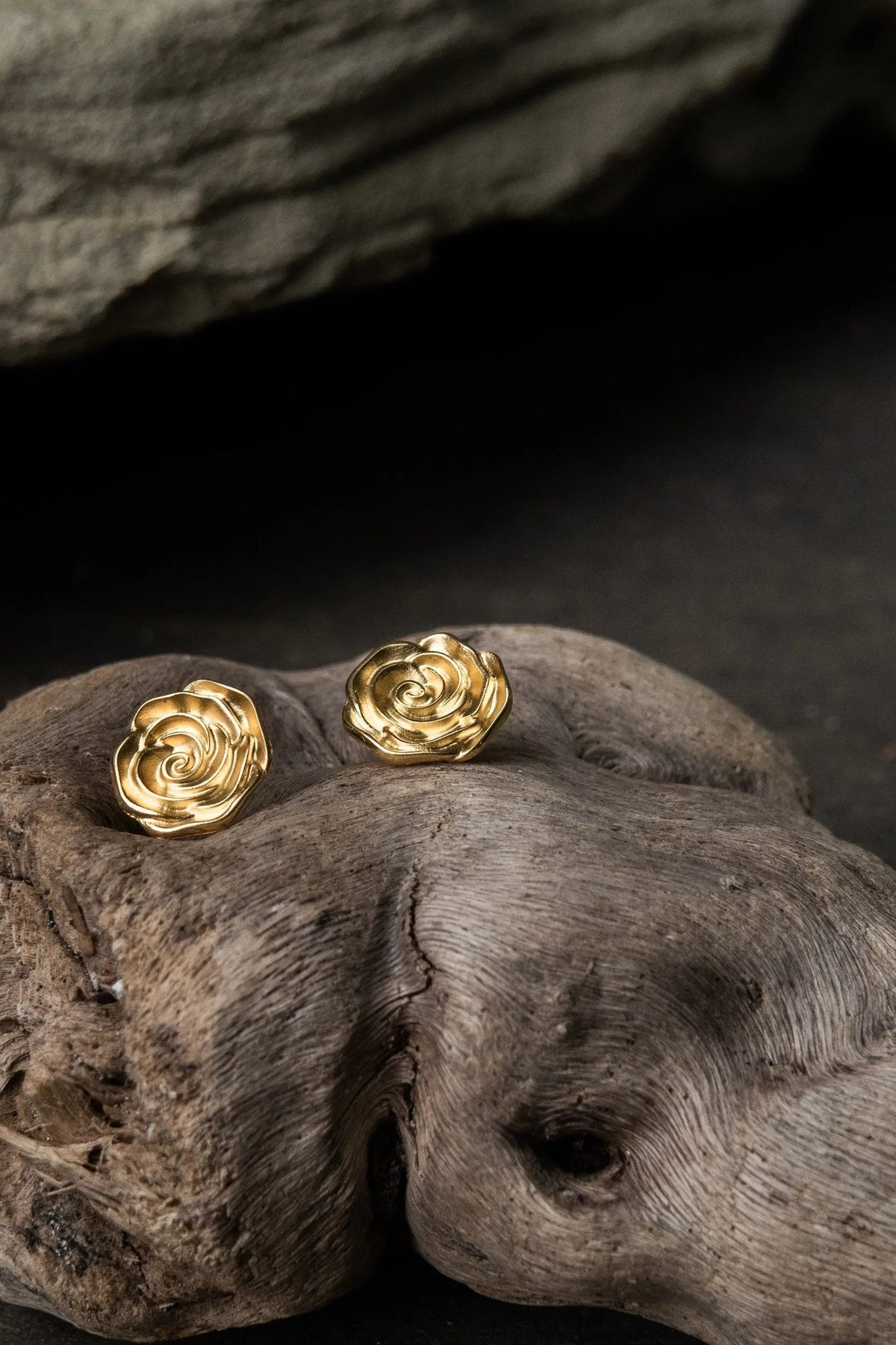 Rose earrings in gold-tone metal, shaped as sculpted roses with layered petals and a polished finish