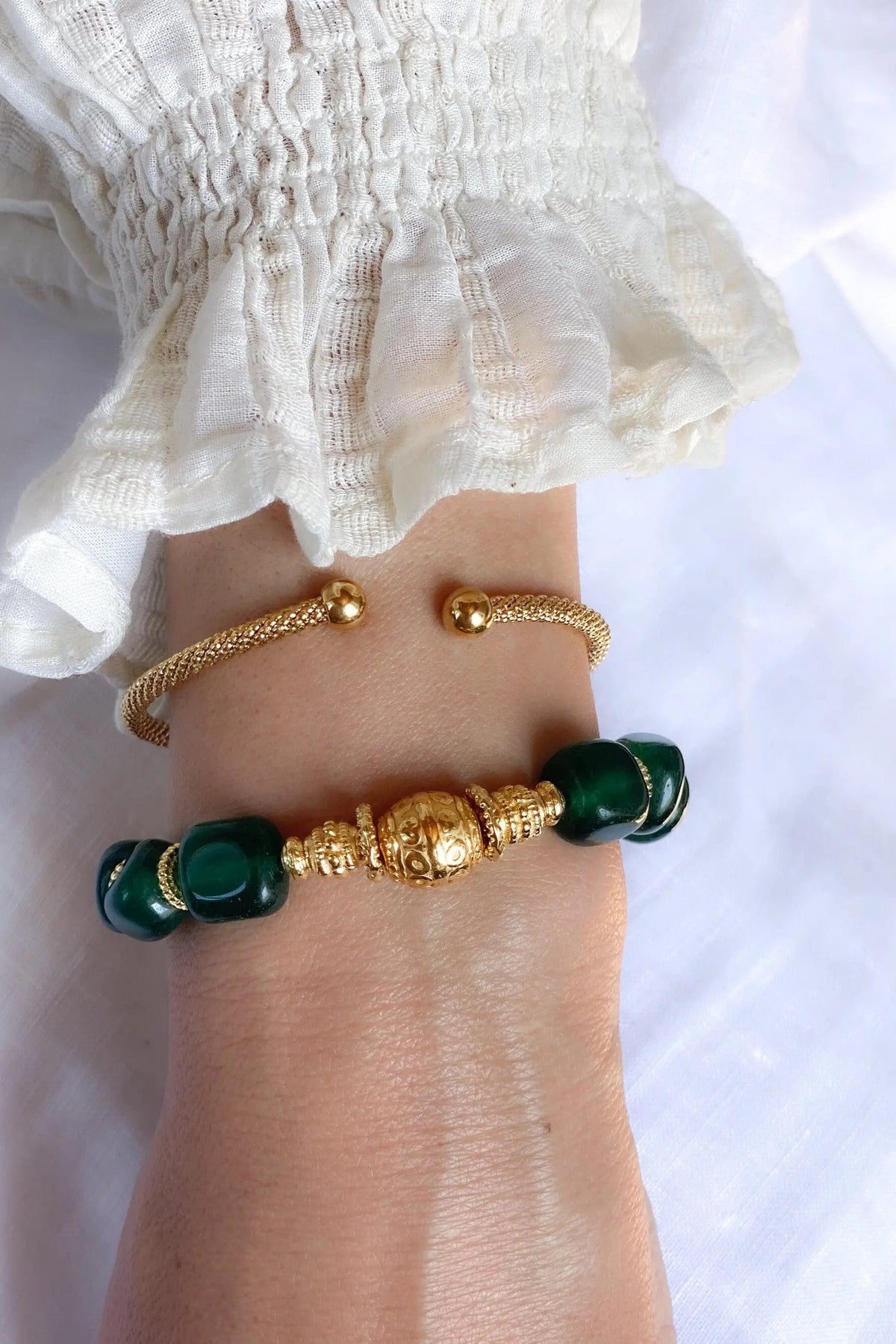 ROXANI Emerald Green bracelet with polished dark green stones and ornate gold-tone beads on a delicate chain