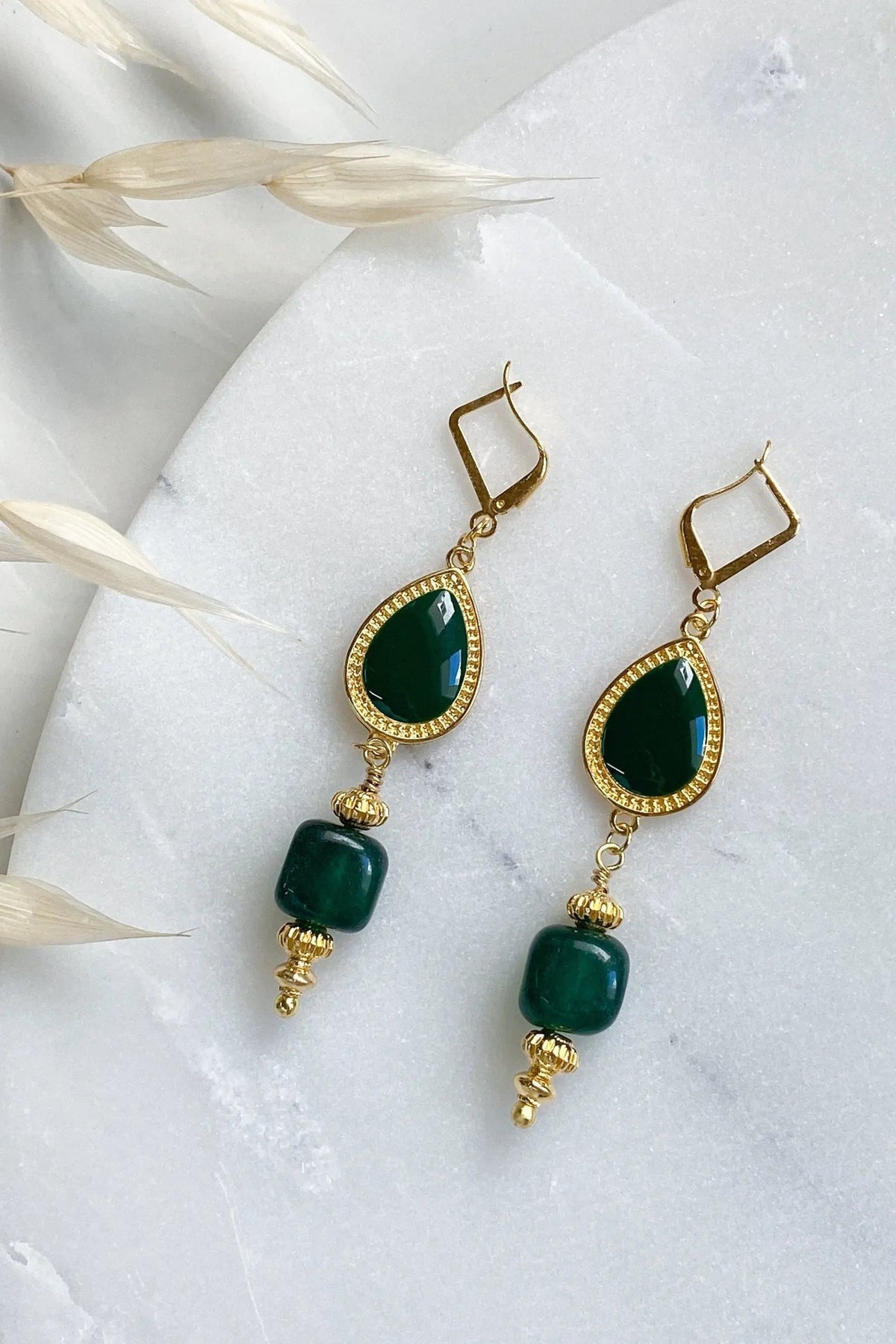 ROXANI Emerald Green earrings with gold-tone settings, deep green teardrop stones and rounded beads in a dangling design