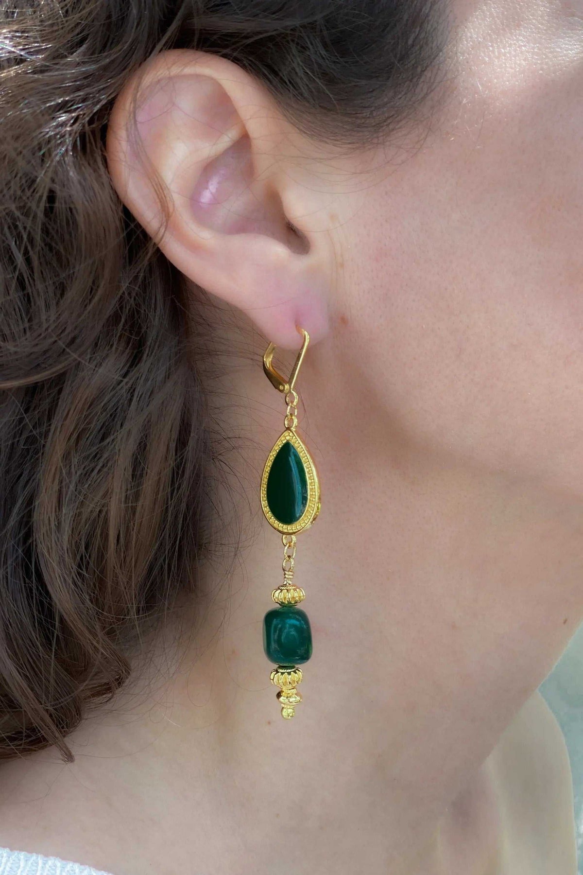 ROXANI Emerald Green statement earring with gold-tone detailing, a deep green teardrop stone and carved bead