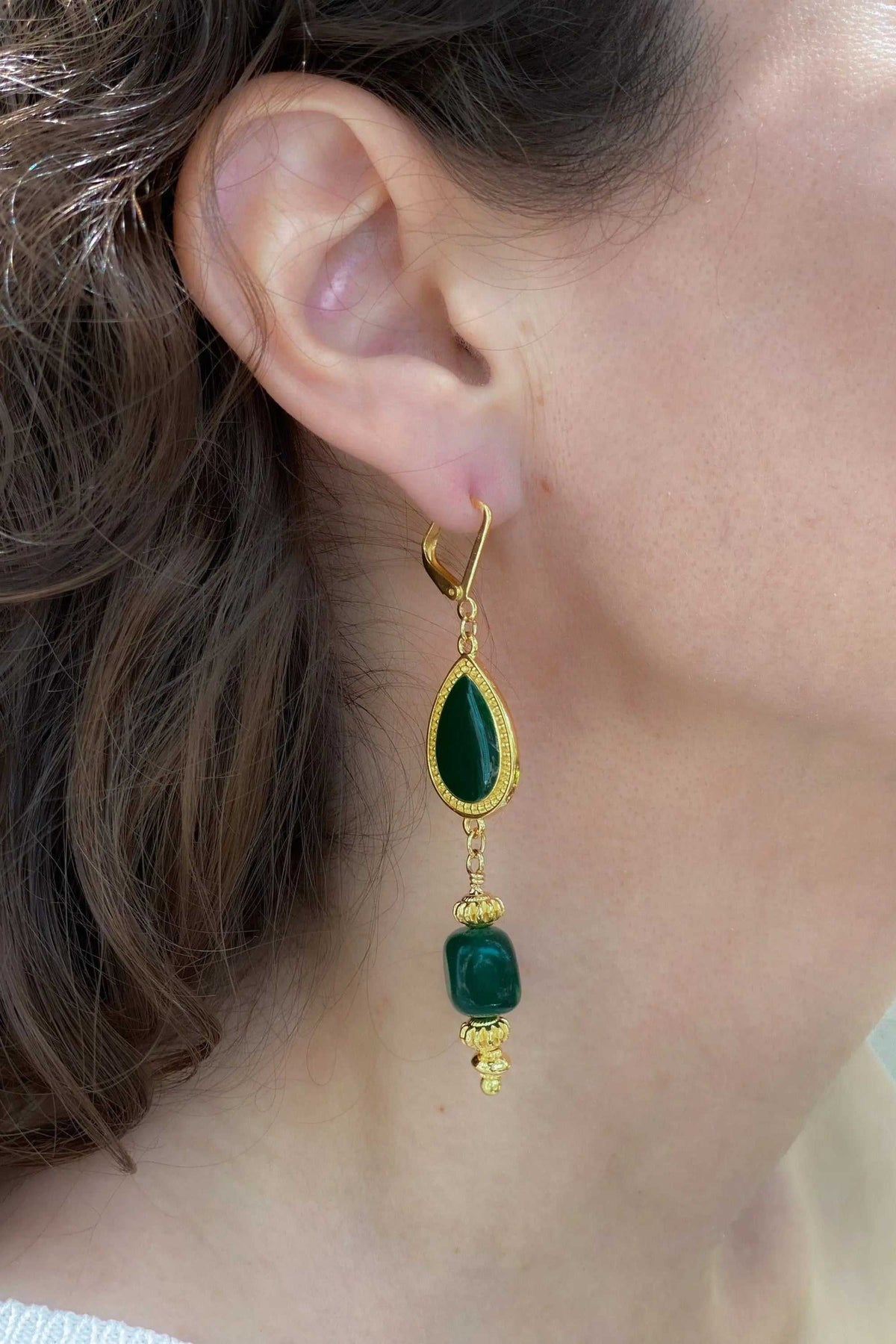 ROXANI Emerald Green statement earring in gold-tone metal, with deep green stones, ornate settings and dangling details