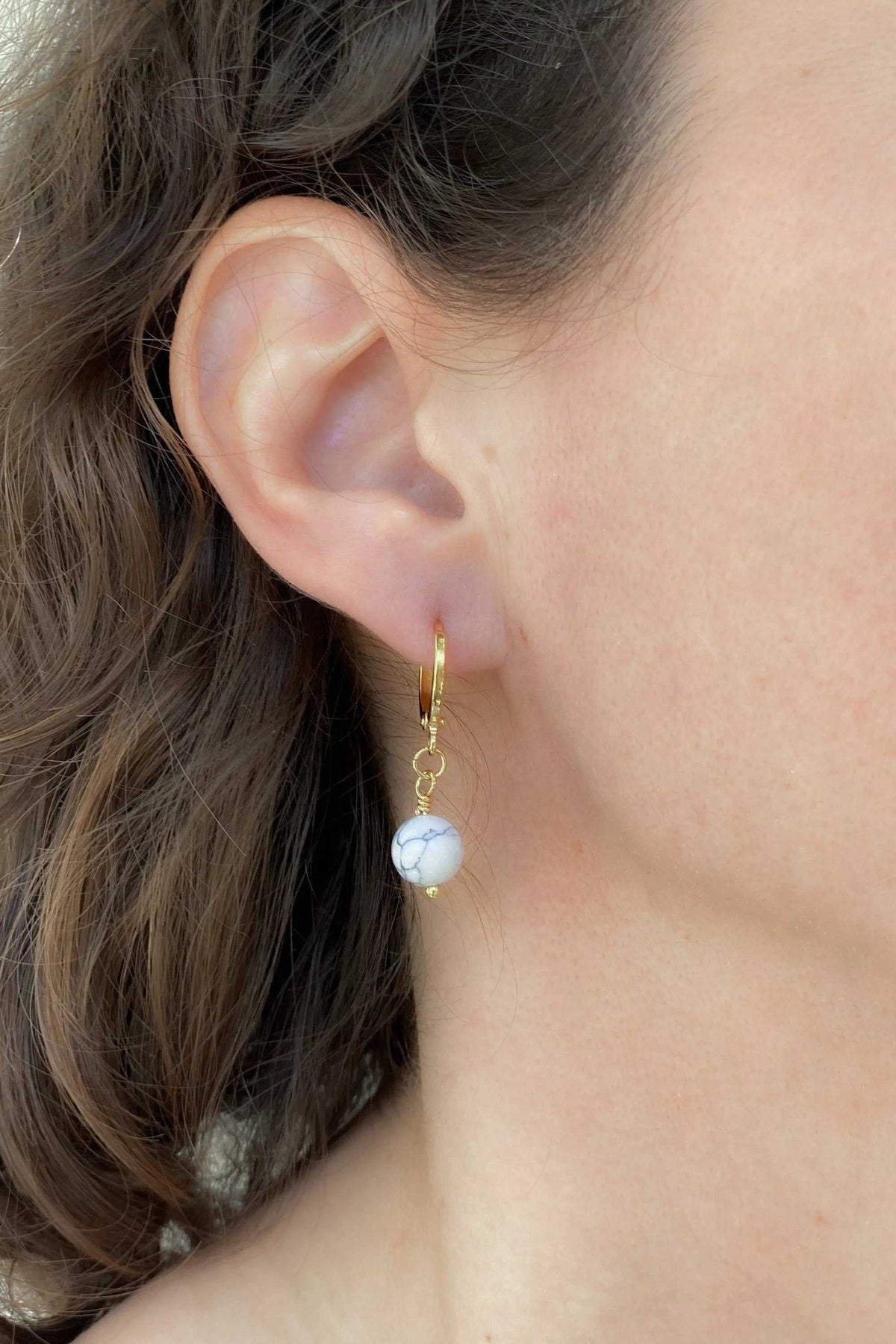 SABINA Gold Huggie Hoop Earrings with a delicate gold hoop and round white pearl drop charm