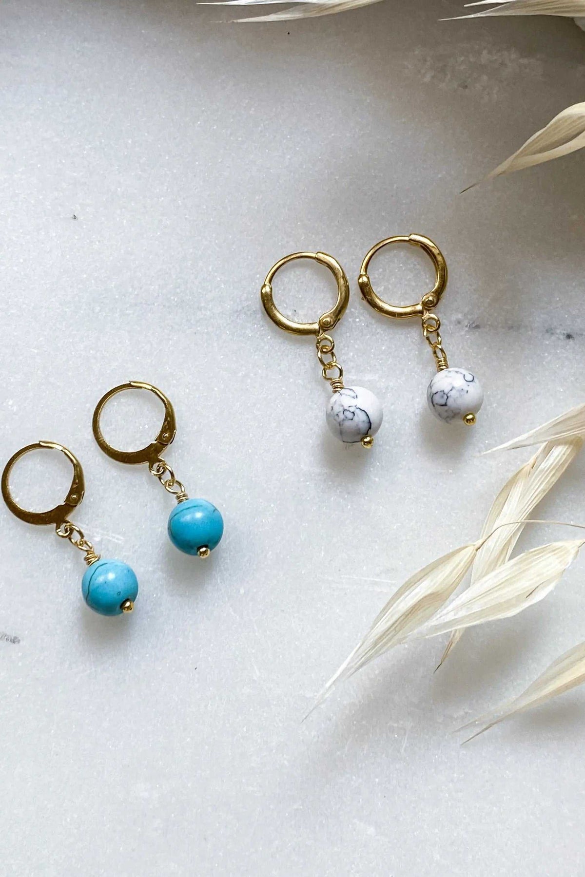 SABINA Gold Huggie Hoop Earrings in gold-tone metal with dangling white marbled and turquoise beads