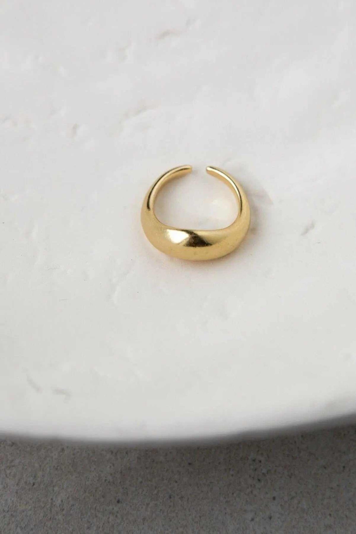 Sade bold ring in polished gold-tone brass, with a chunky rounded band and an open adjustable design