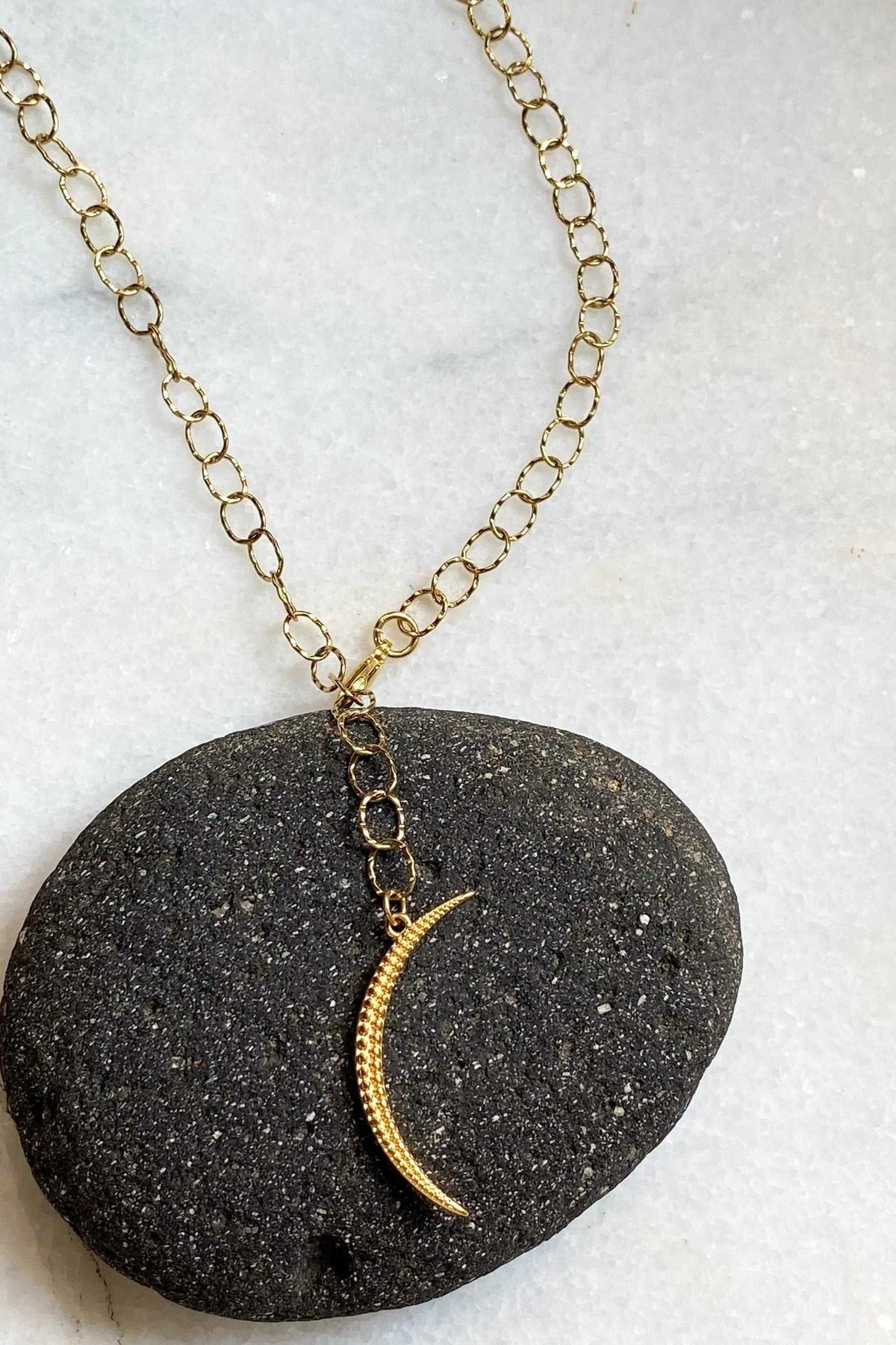 SELENE Moon Lariat Necklace with a gold-tone steel chain and textured crescent moon pendant