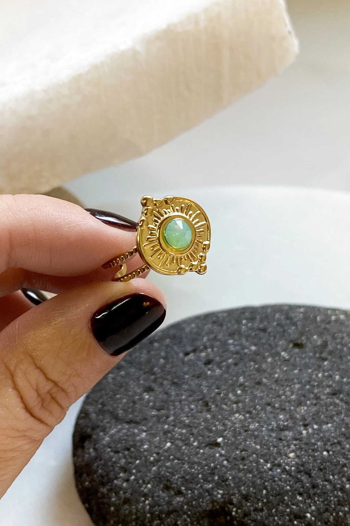 SEZAN Gold Stone Ring in gold-tone metal with a round green crystal and ornate sunburst square setting