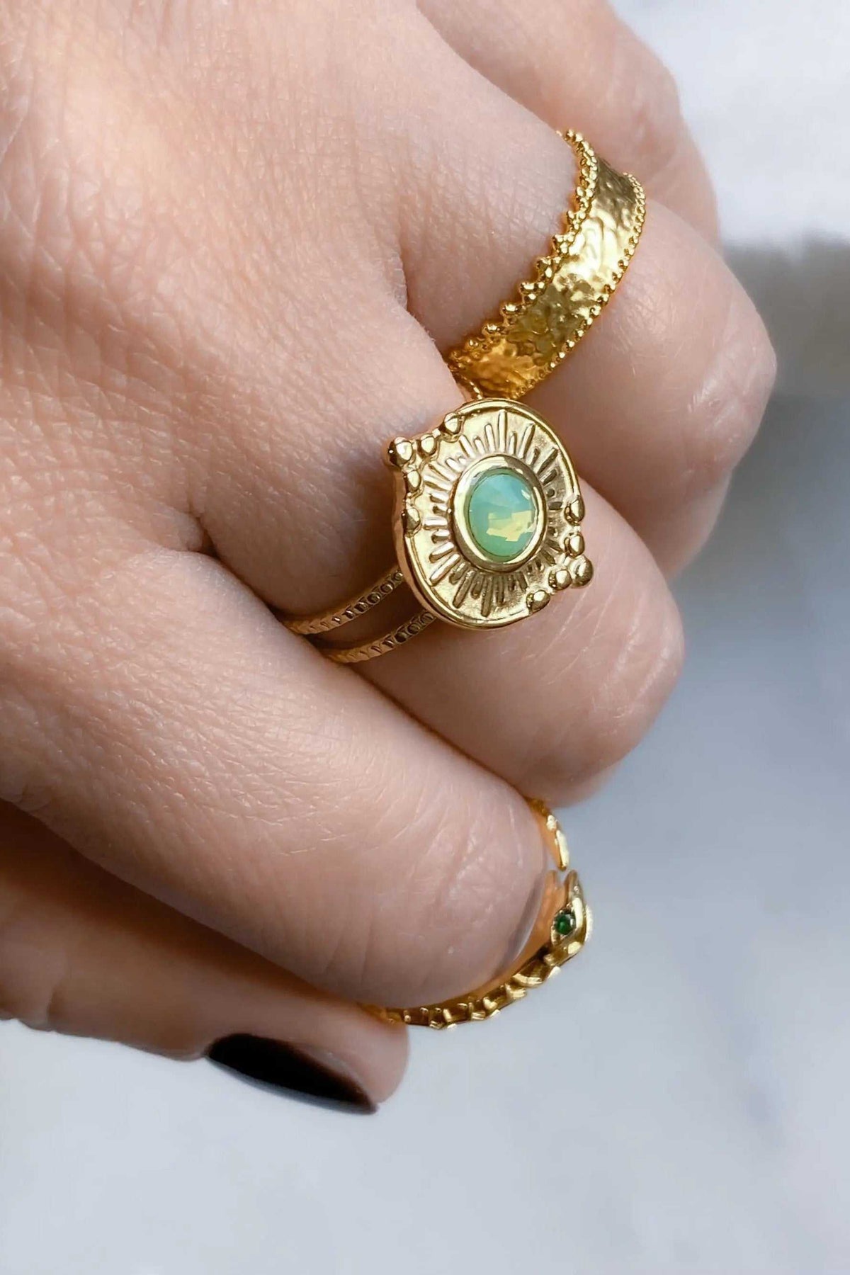 SEZAN Gold Stone Ring in textured gold with an oval green stone set in an ornate raised bezel