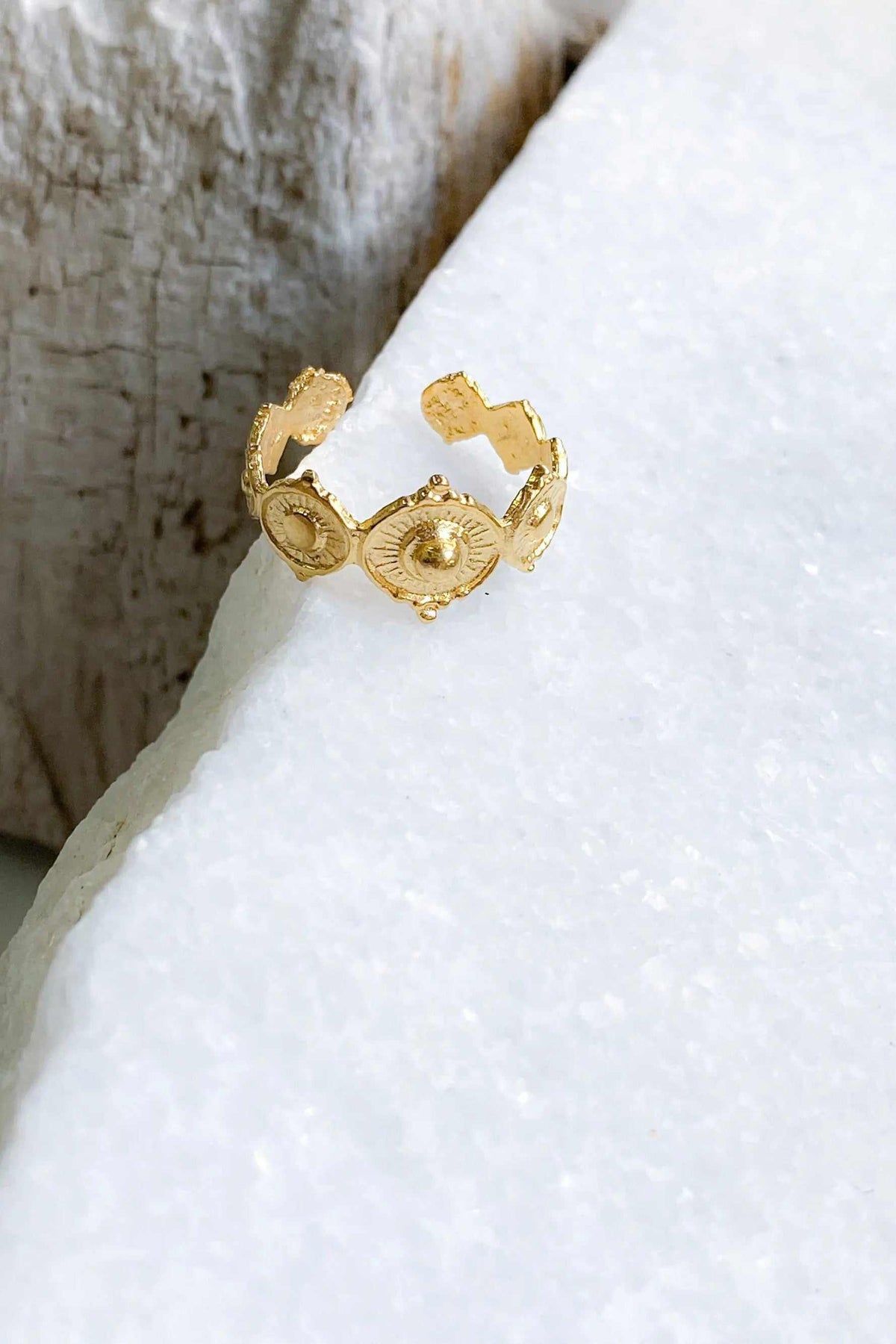 SHARMA Dotted gold ring in a gold-tone finish, featuring an adjustable open band with ornate oval dotted motifs