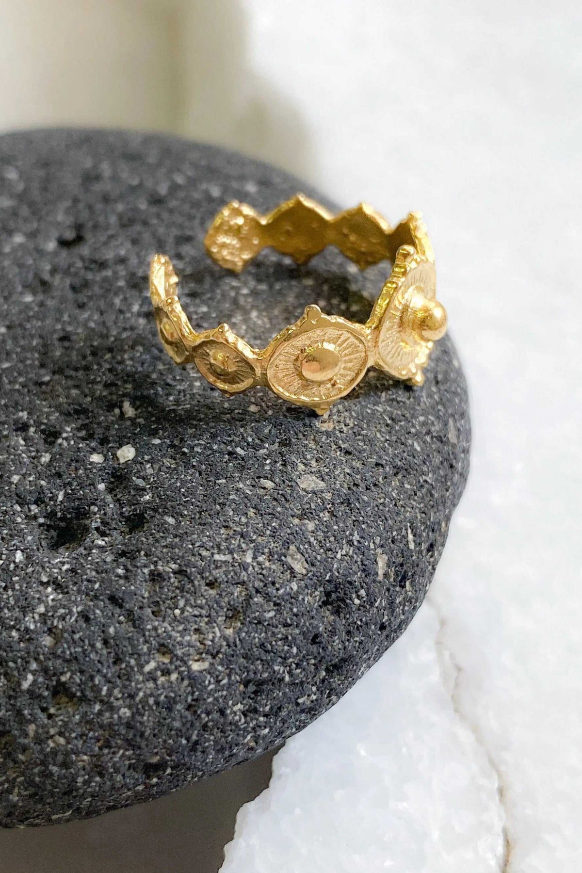 SHARMA Dotted gold ring in textured gold-tone metal, featuring an open adjustable band with raised circular dotted motifs
