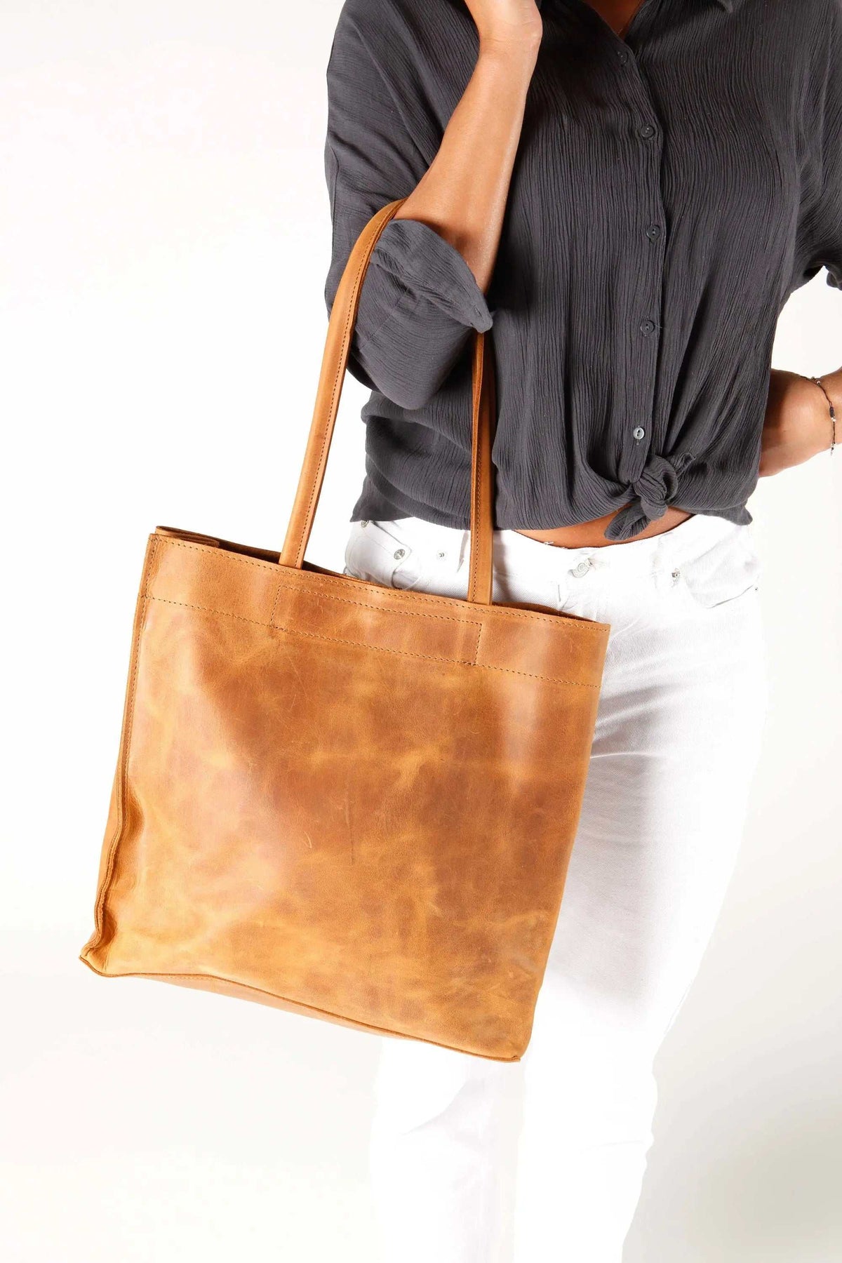 shoppers bag in warm cognac brown leather with a smooth finish, rectangular tote shape and long shoulder handles