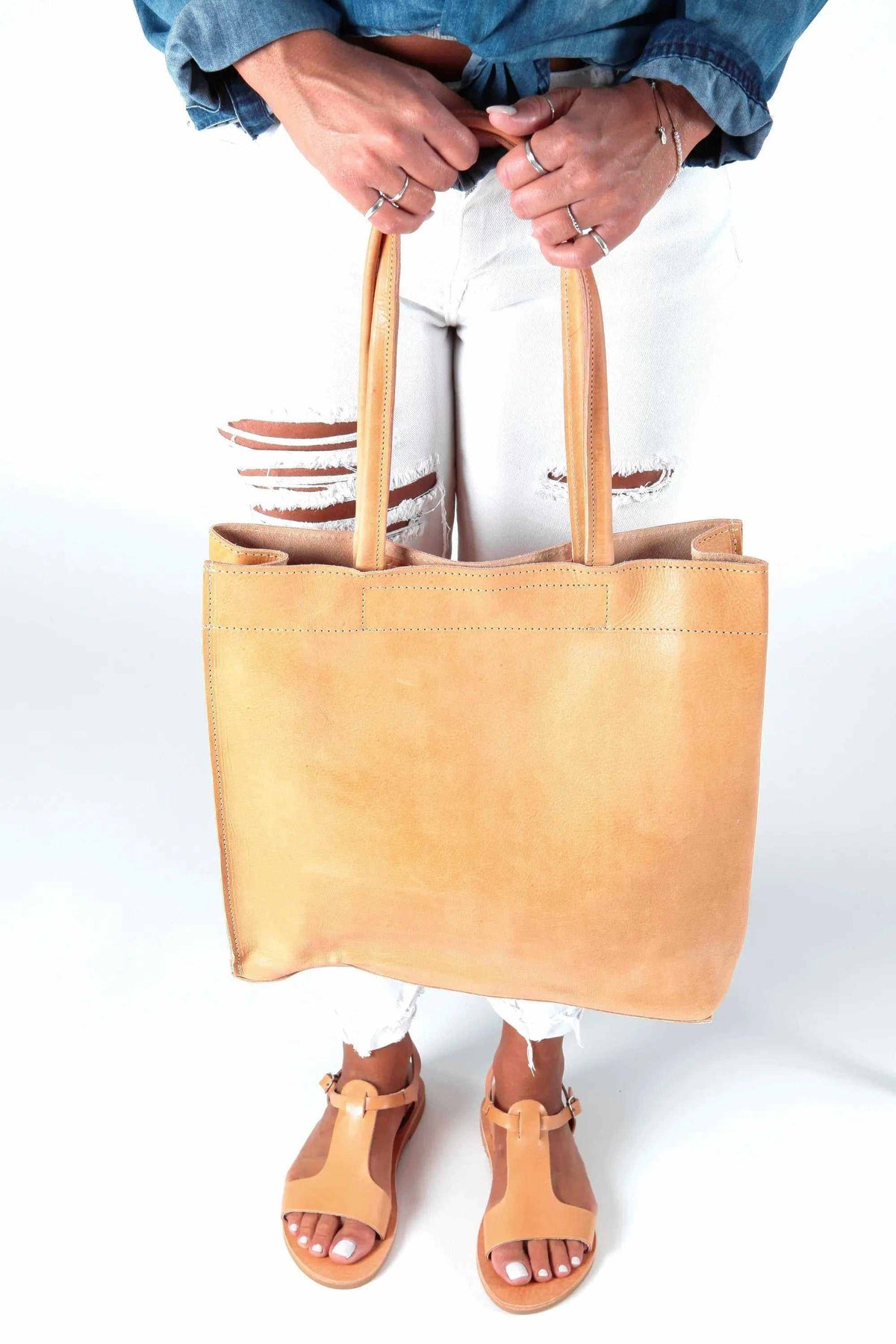 shoppers bag in warm tan leather with a minimalist rectangular shape, long shoulder handles and open top