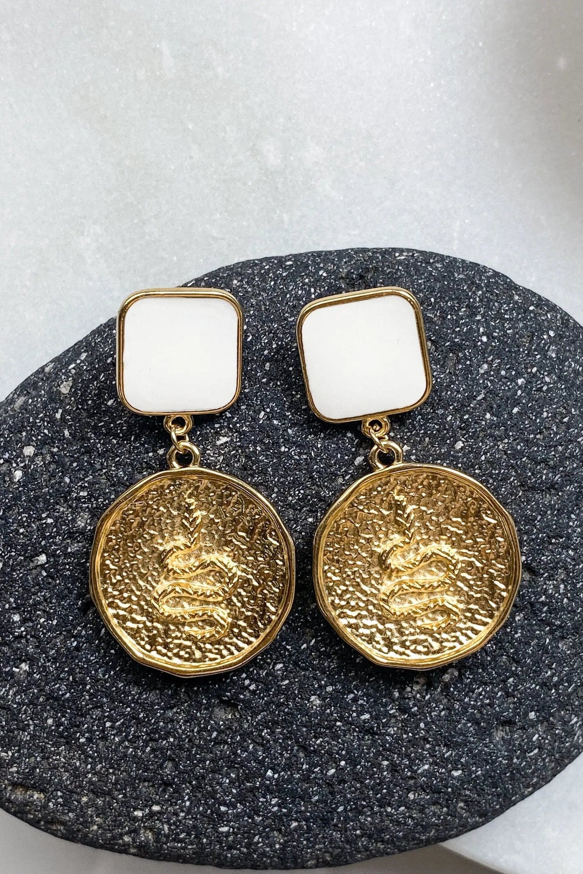 SNAKE Gold Coin Earrings with gold-tone coin medallions, raised snake motifs, and white square stud tops