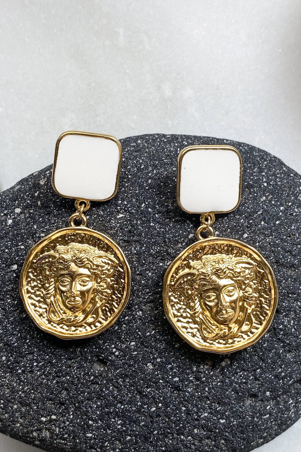 SNAKE Gold Coin Earrings with gold-toned square studs and round embossed coin charms featuring sculpted faces