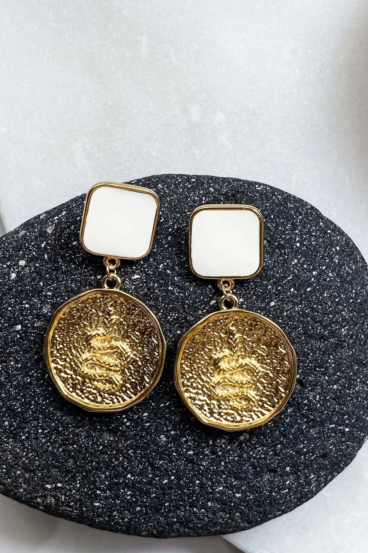 SNAKE Gold Coin Earrings with textured gold-tone round medallions, white square tops, and a bold dangling design