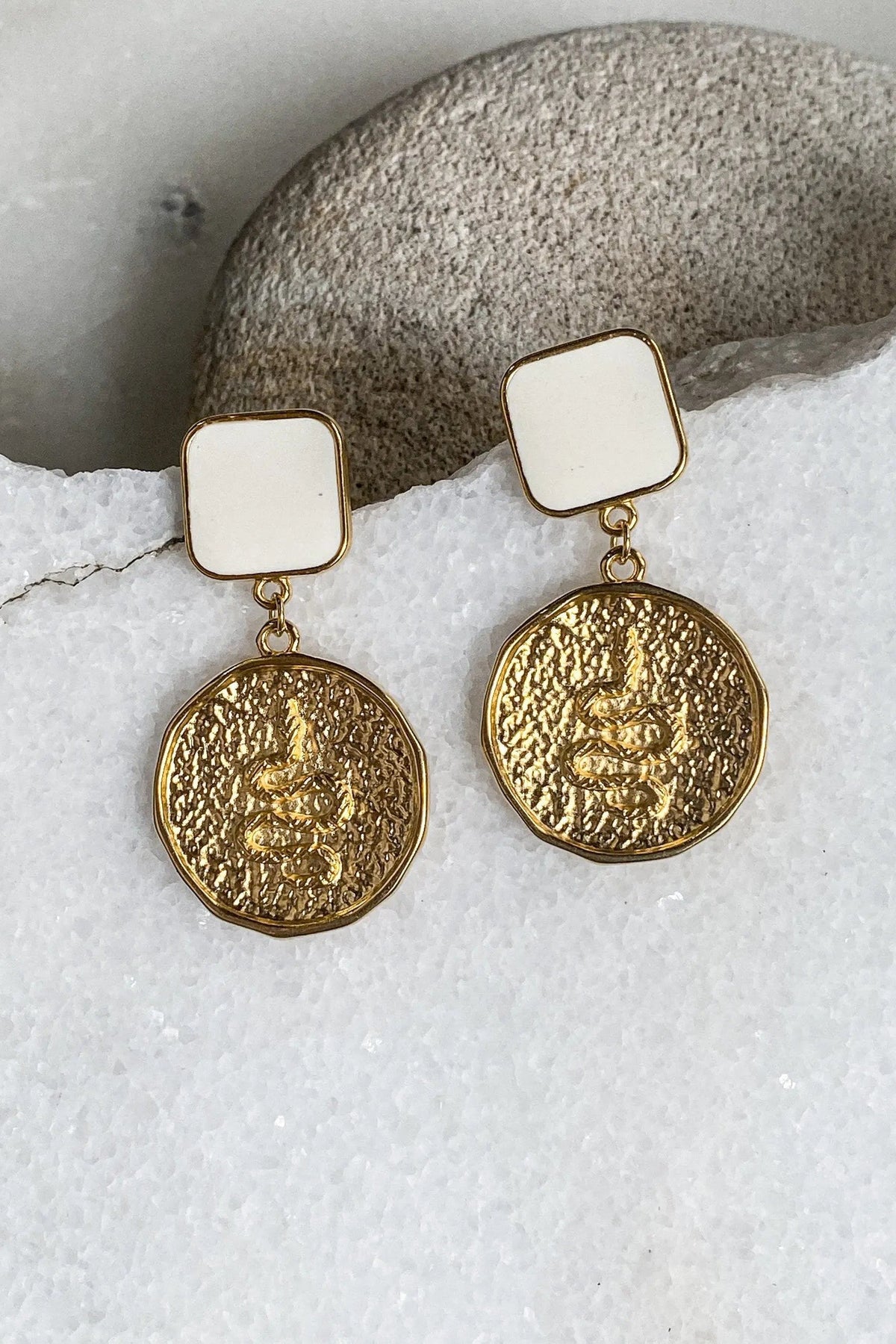 SNAKE Gold Coin Earrings with textured gold-tone round coin charms, glossy white square studs, and dangling links
