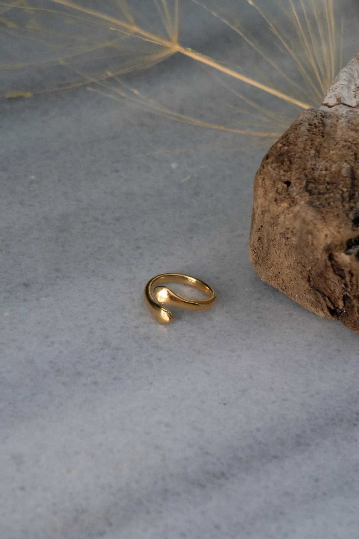 Snake Wrap RING in polished gold-tone metal, with a smooth adjustable open band and rounded ends