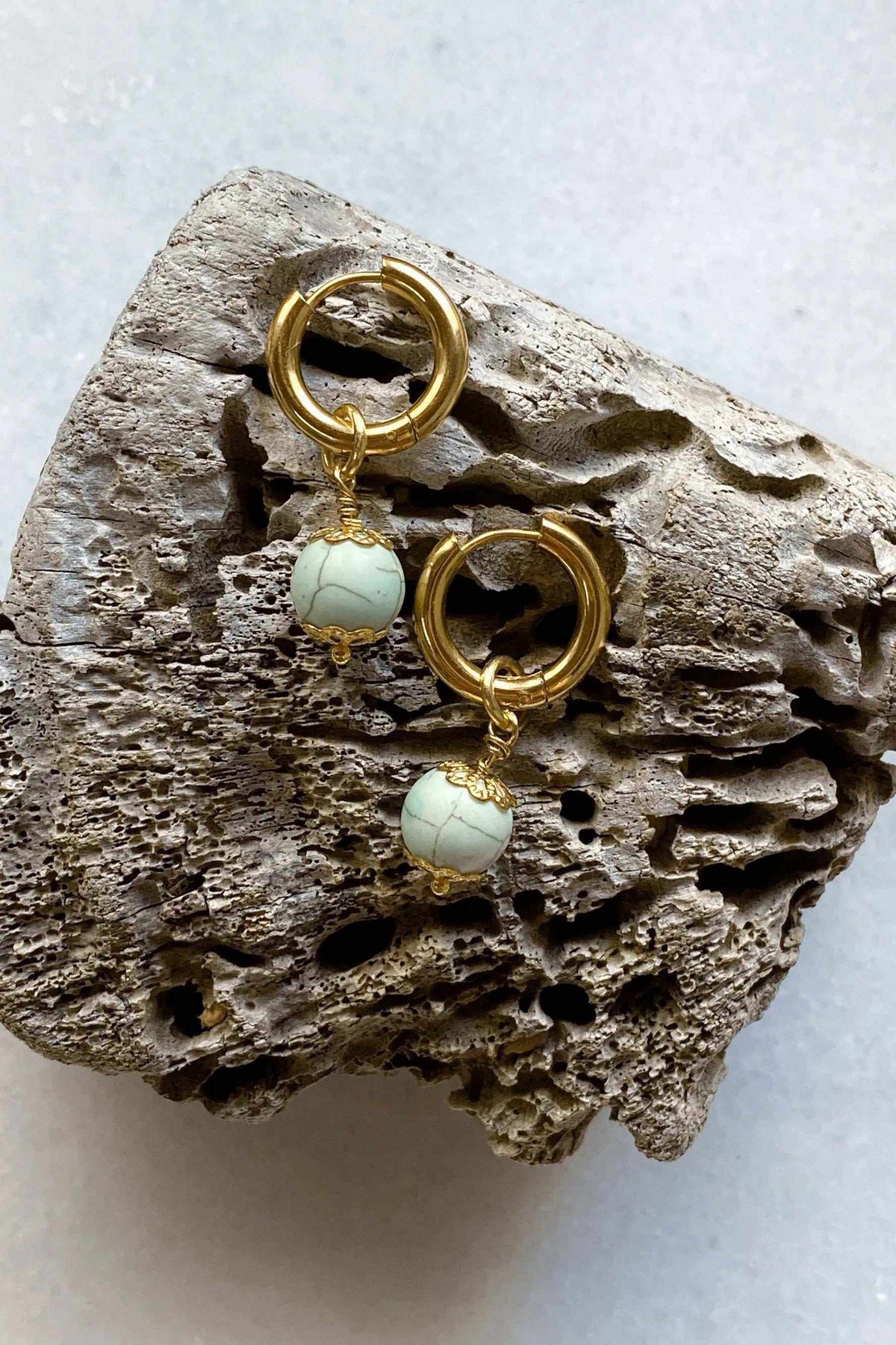 SORAYA medium earrings, gold-tone huggie hoops with round pale blue textured gem charms