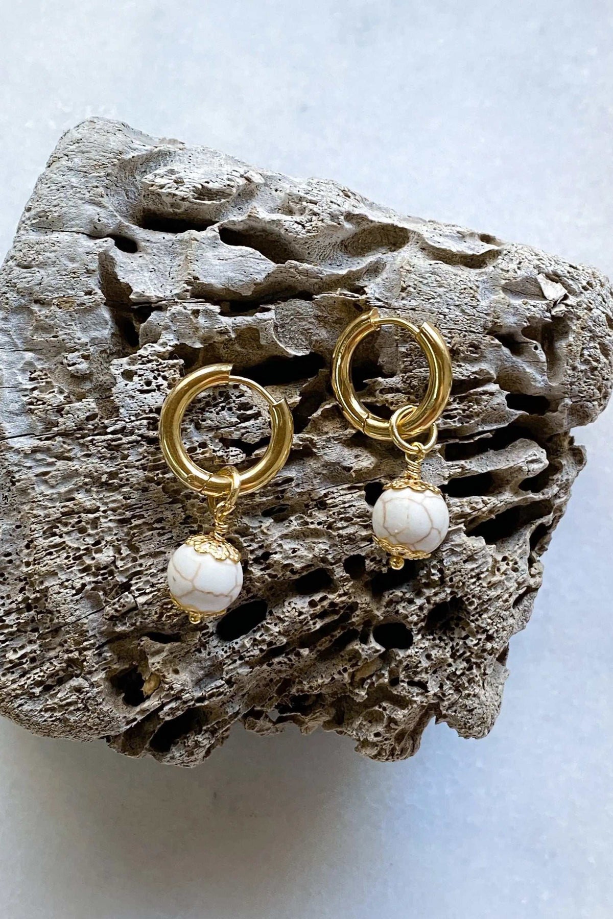 SORAYA medium earrings in gold-tone metal with small white round gem charms and decorative gold caps